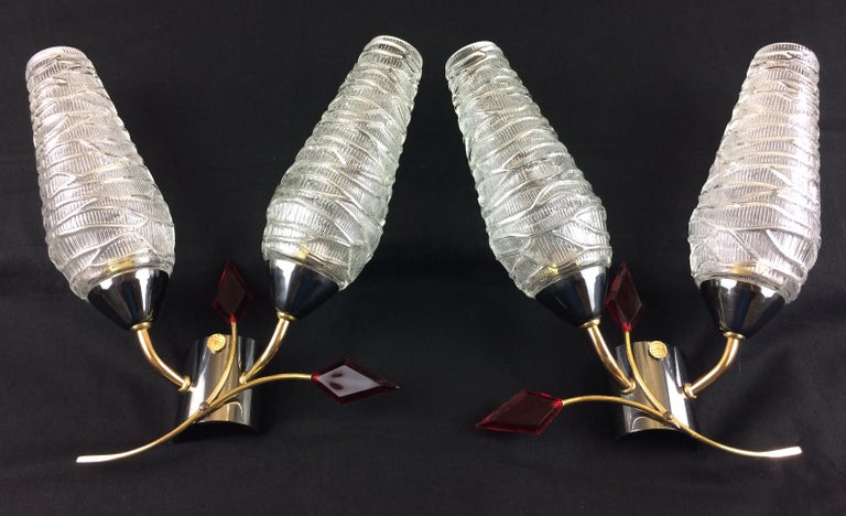 An elegant pair of midcentury wall sconces by Maison Arlus, 1950s-1960s, France.
Brilliant molded glass conical light globes, Lucite points, brass body. All original, Mid-Century Modern.
These 1950s-1960s originals feature two conical glass shades