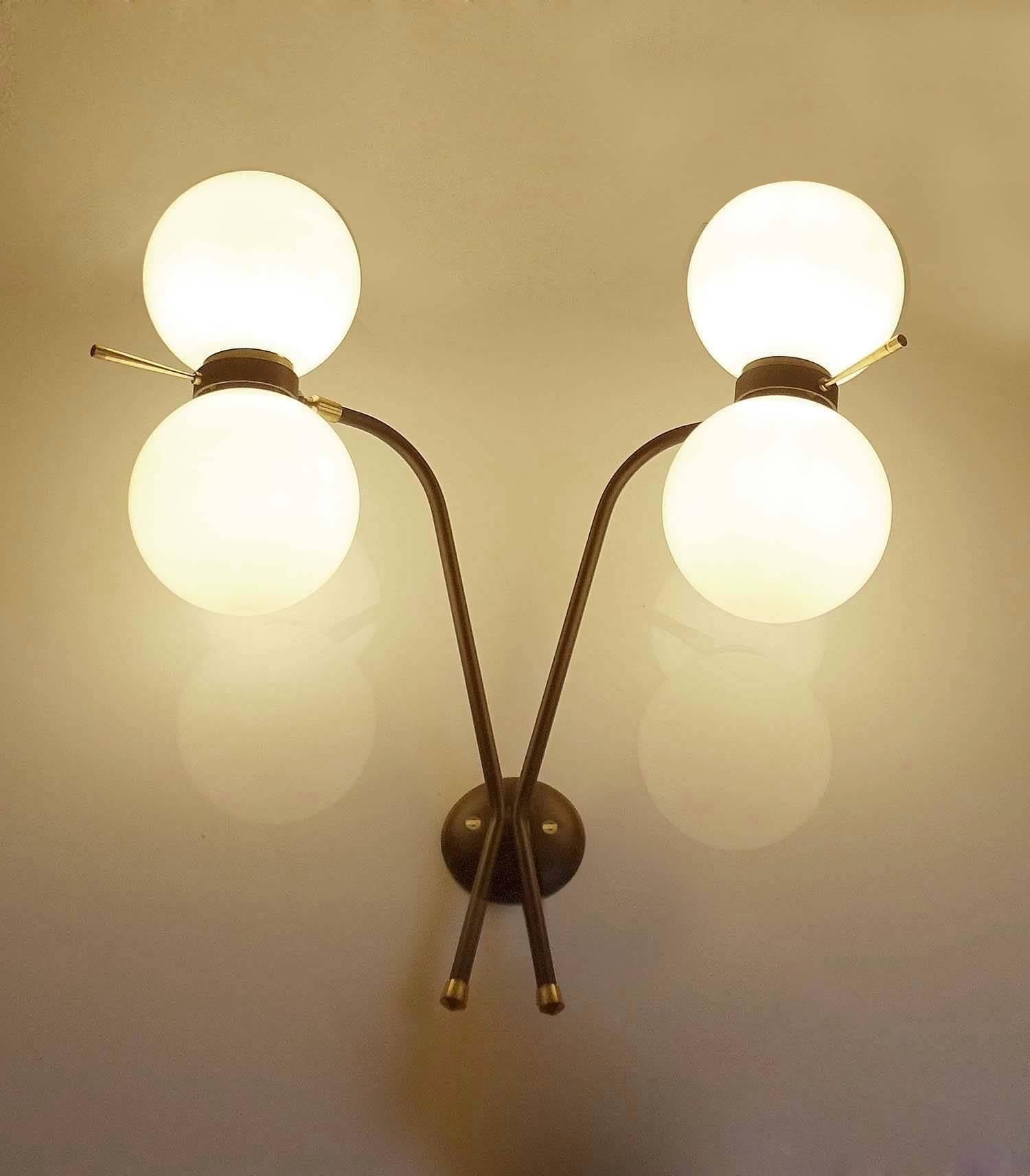 All our light´s electricals are professionally checked and tested for worldwide use
Pair of exceptional, large midcentury sconces by Maison Arlus (Arts et Lustres), France, circa 1965, featuring an X-shaped black enameled structure, jointed ring