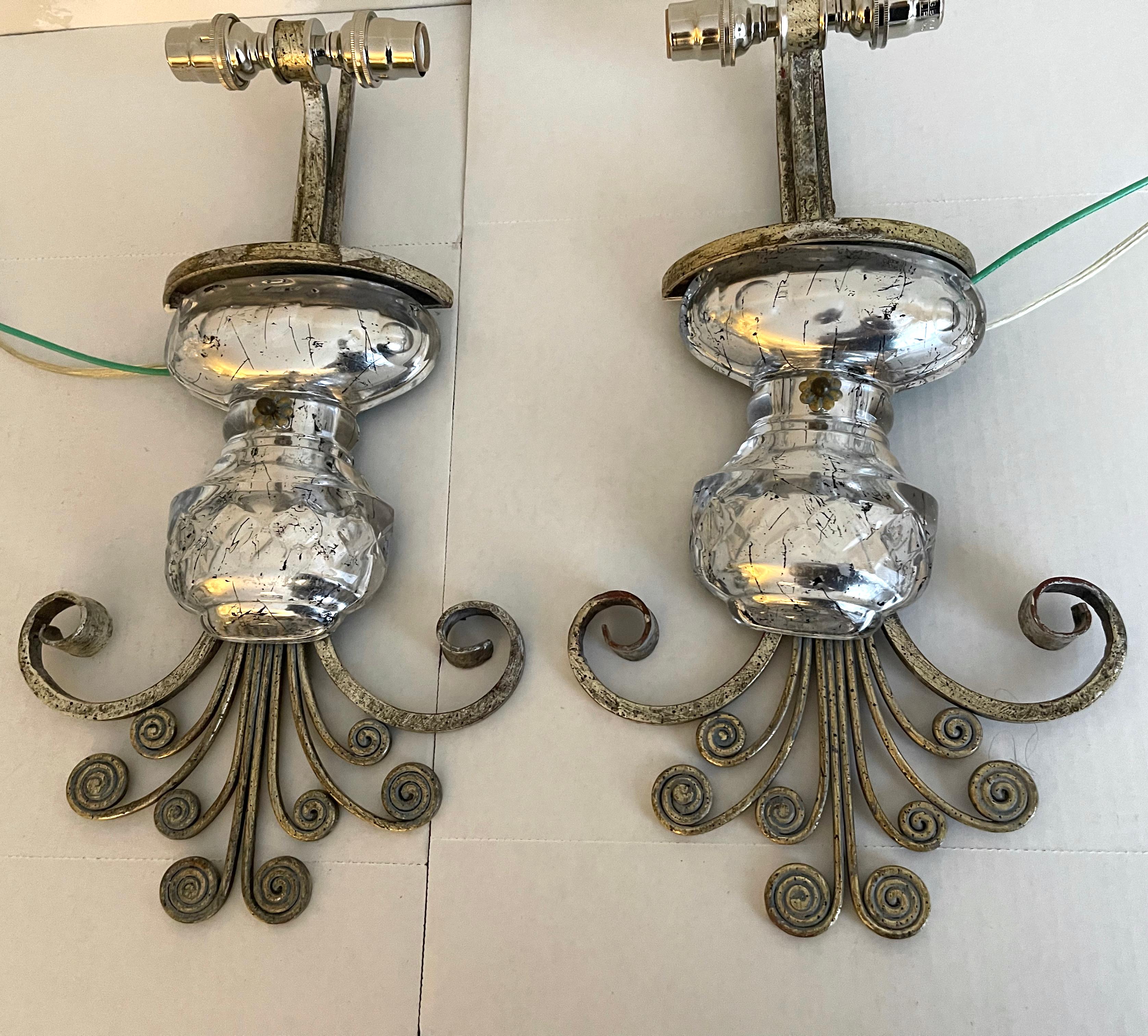 Pair of 1980s French mercury glass sconces attributed to Maison Bagués. Silver gilt iron painted finish. 
Newly rewired. Each light takes two chandelier bulbs (not included).

Please note that additional components such as back plates may be