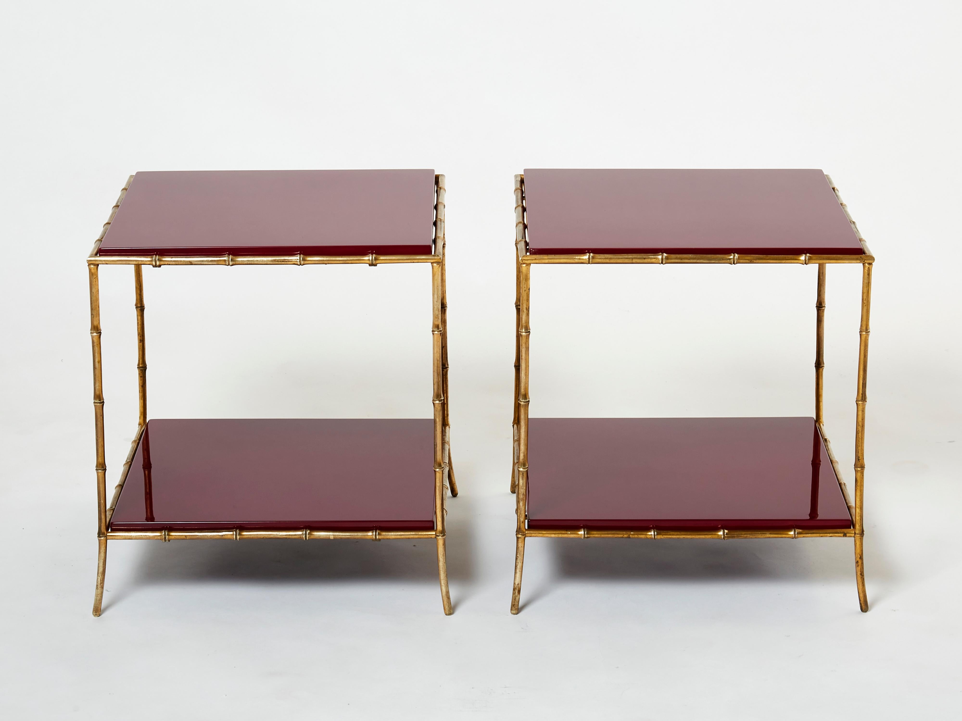 This beautiful pair of two-tier end tables by French house Maison Baguès was created with solid bamboo shaped brass and beautiful garnet red lacquer tops in the early 1960s. The lacquered tops are timeless and smooth, while the brass bamboo feet