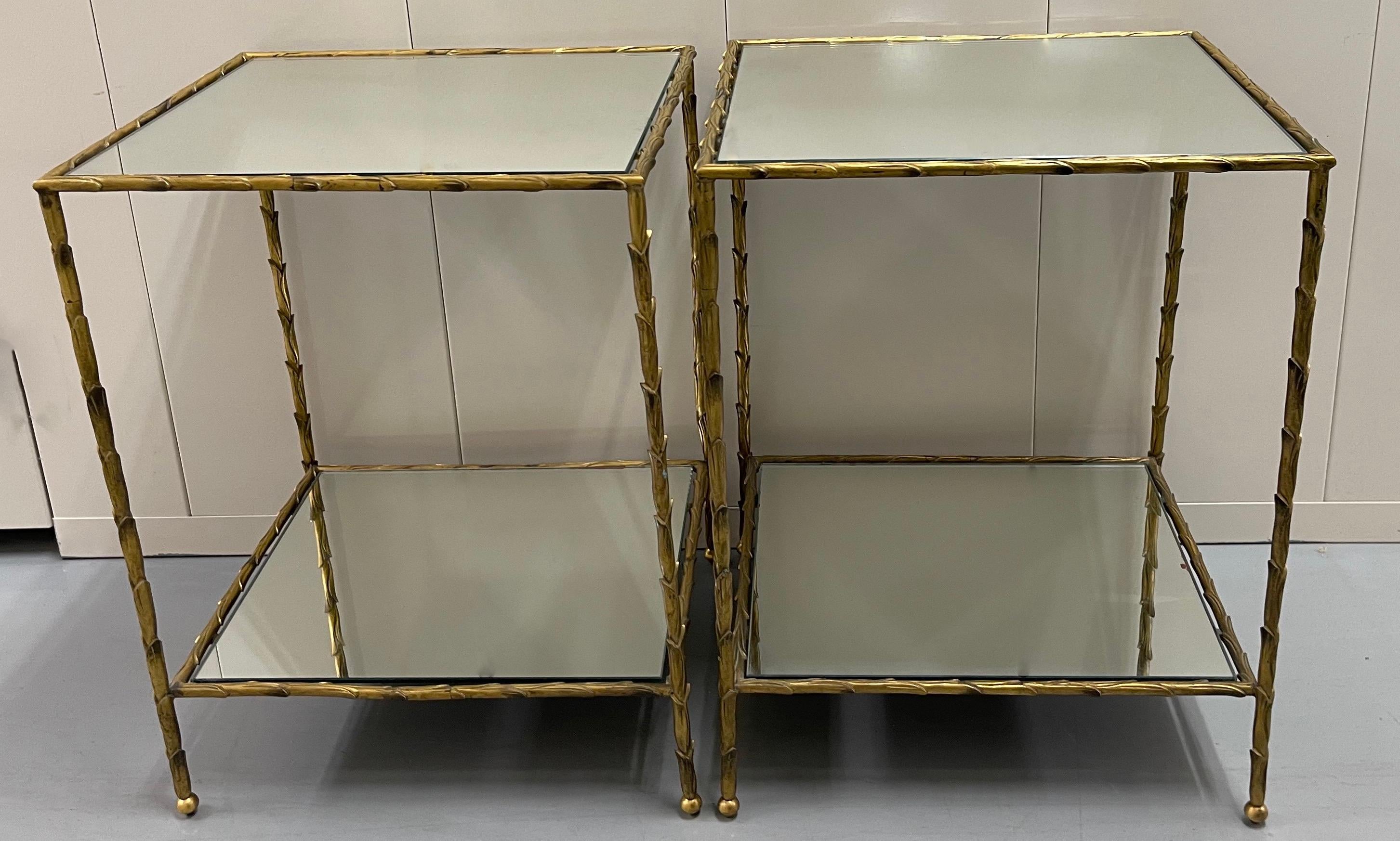 Pair of midcentury French two-tier brass simulated palm frond two tier side tables. Mirrored glass inserts.

First shelf of each table is  5.25” tall from the base. 