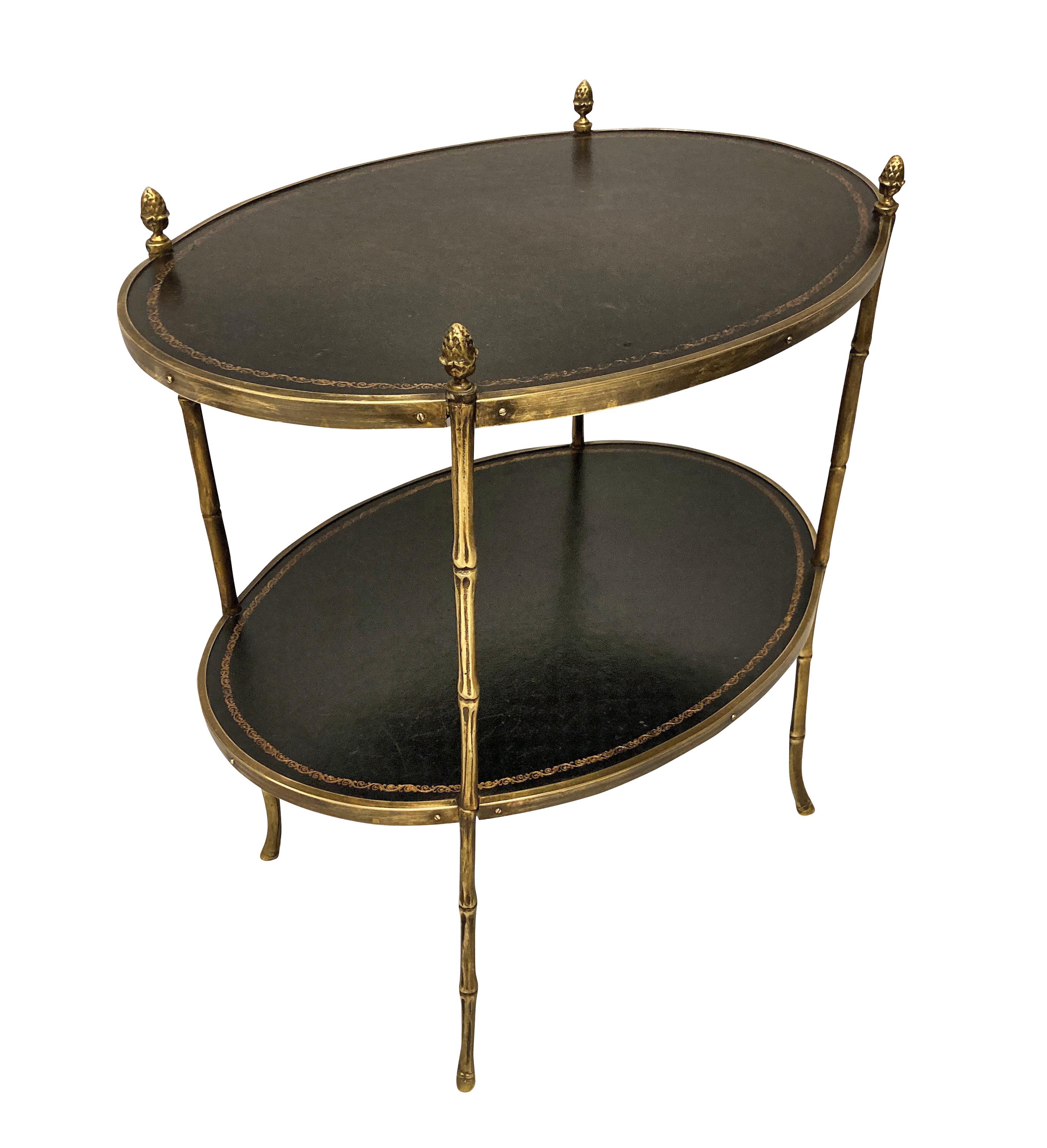 A pair of French étagère occasional table by Maison Baguès. In brass faux bamboo, with tooled leather tops in a very dark green.