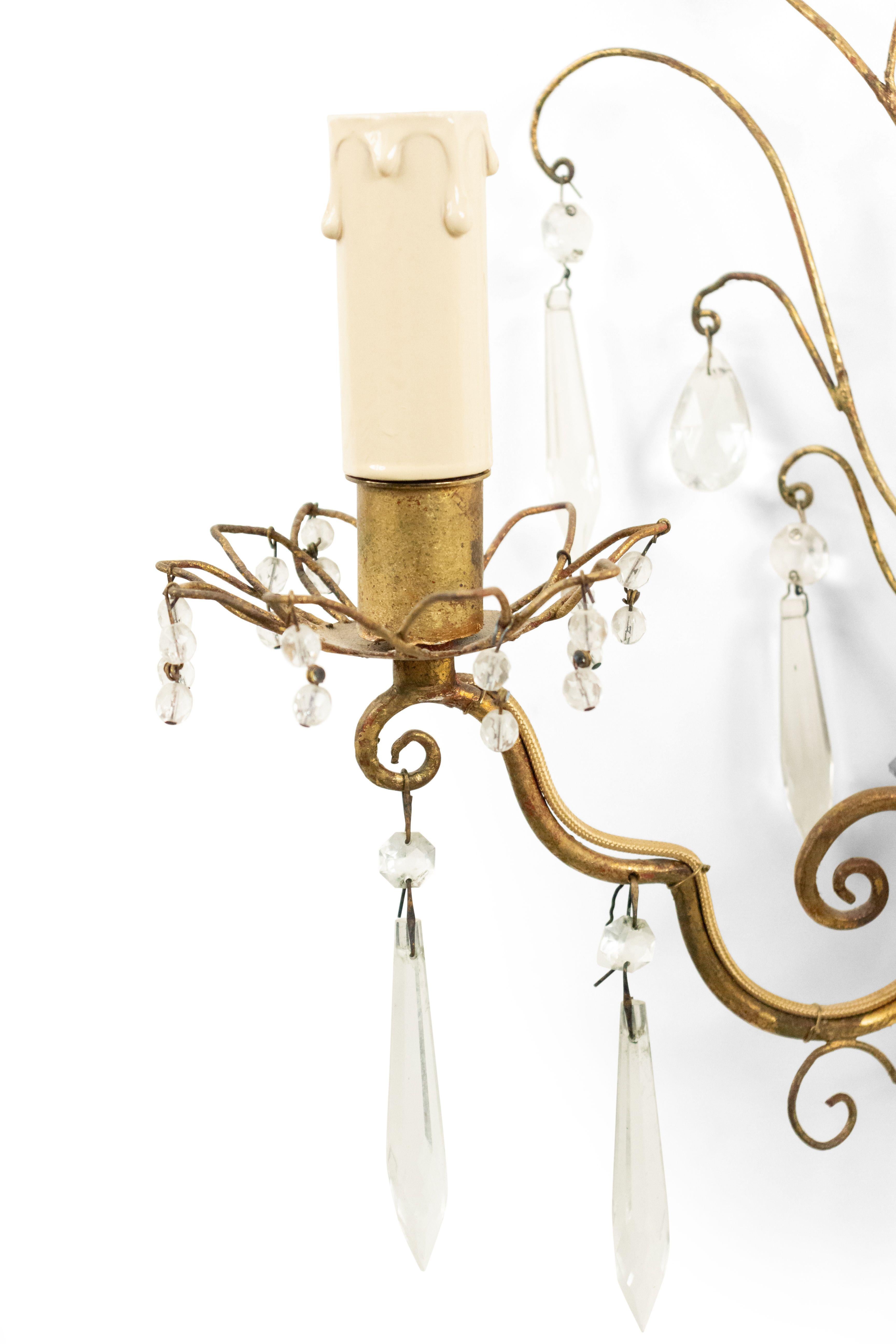 PAIR of French mid-century (1940's) gilt metal wall sconces with scroll wire design and crystal trim with 2 scroll design arms and filigree bobeche. (att: BAGUES) (priced as pair).
      