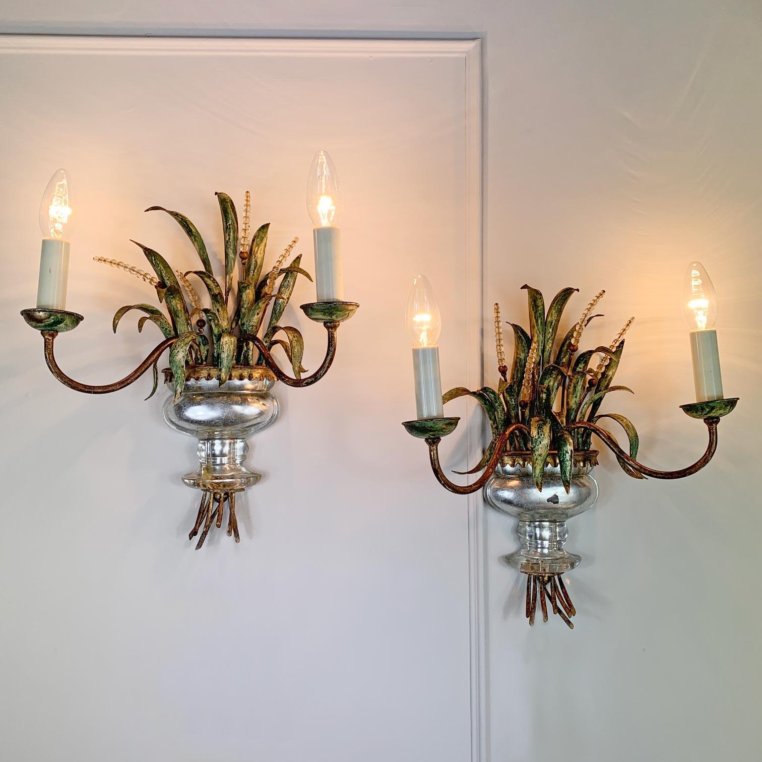 A very rare pair of wheatsheaf wall lights by Maison Bagues, the wheatsheaf form in naturalistic hand painted finish, with faceted crystals and a solid crystal urn to the centre, capped with a gilt gold surround.

These are both in excellent