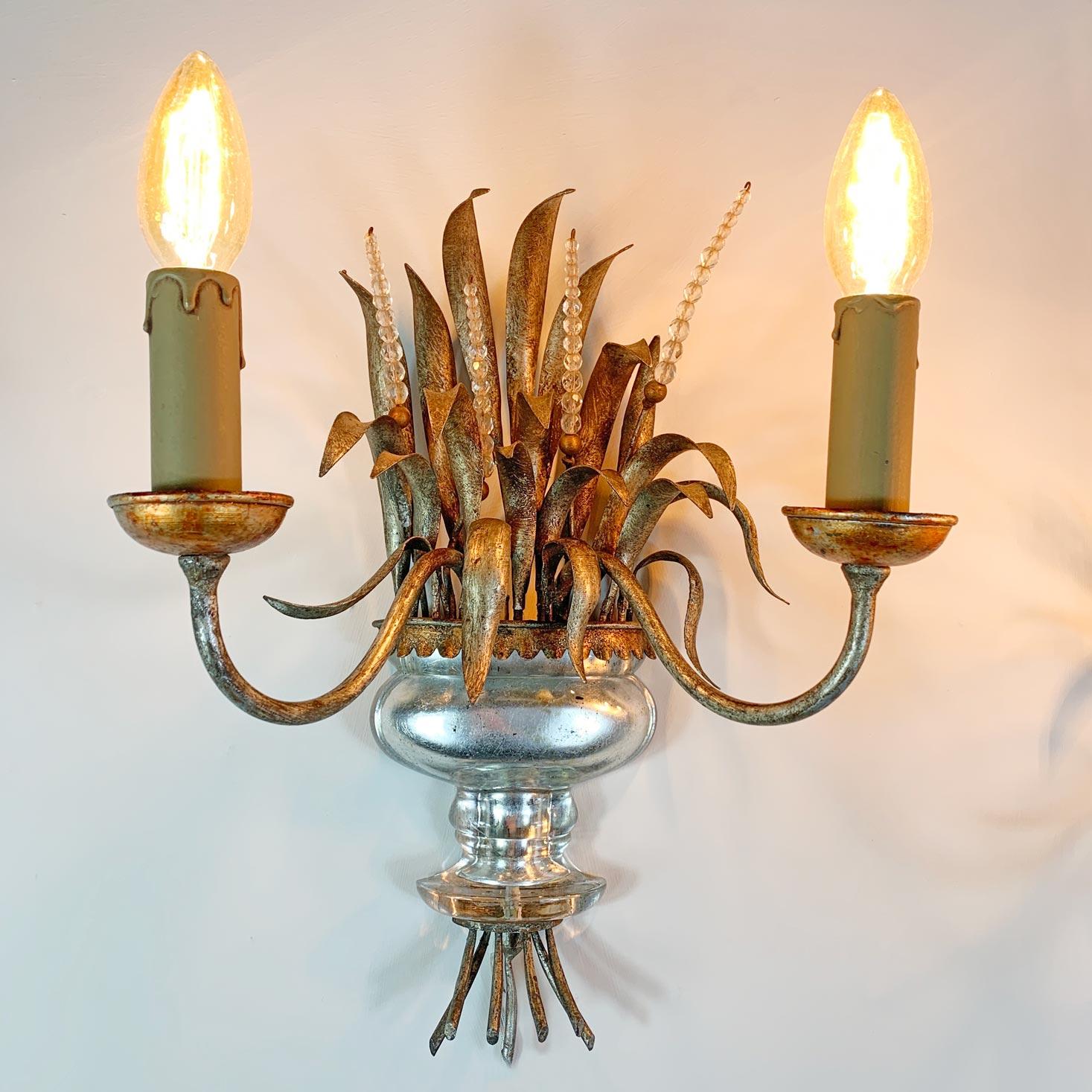 An incredible pair of wall lights by Maison Bagues, the wheatsheaf form in silver gilt, with faceted crystals and a solid crystal urn to the centre, capped with a gilt gold surround.

These are in superb vintage condition and date to the