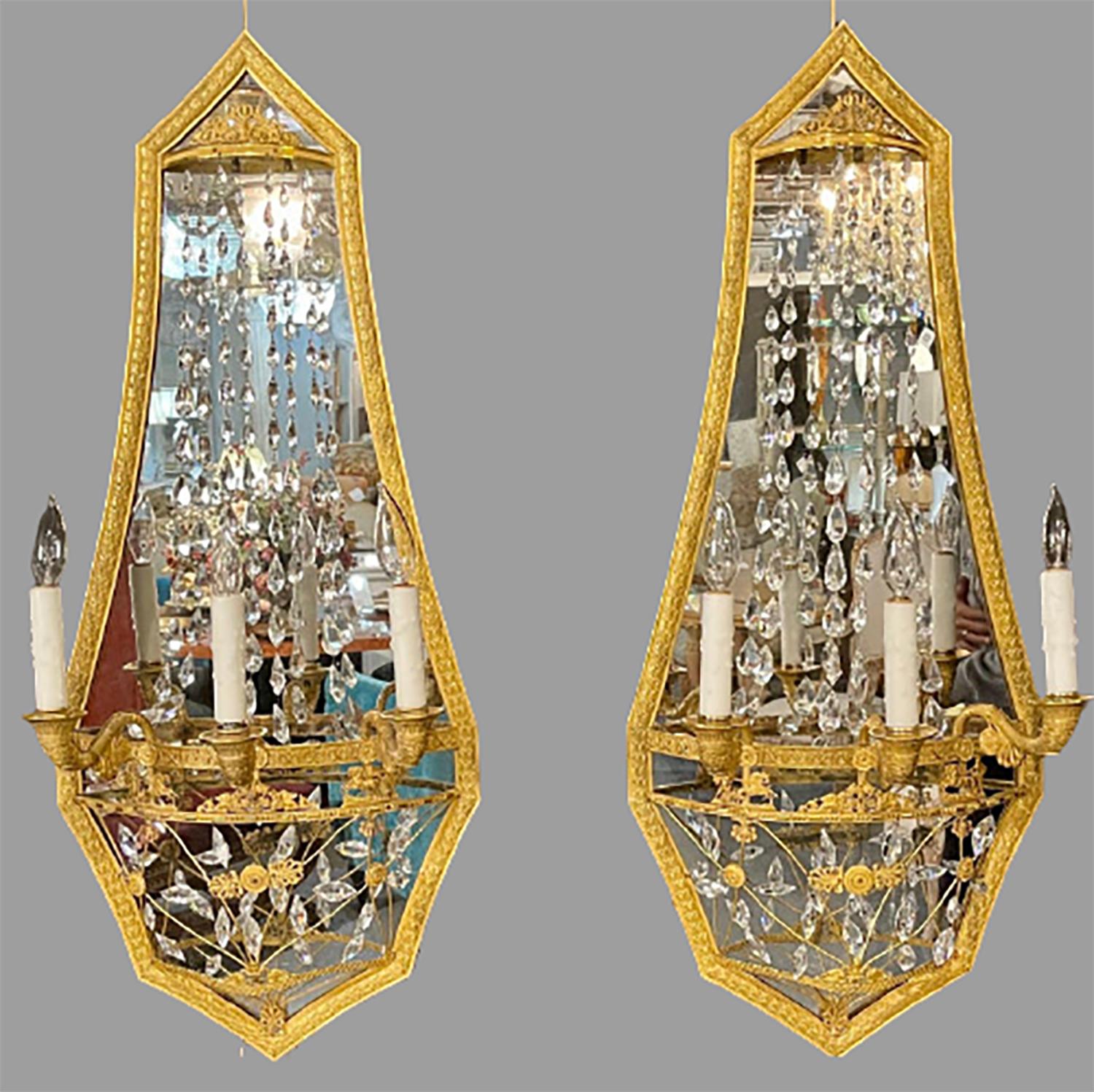 Pair of Maison Baguès mirrored wall lights, sconces. This stunning pair of large and very impressive wall sconces in a dore bronze finish having a Russian neoclassical flair are certain to make a statement in any area of the home. These rare and