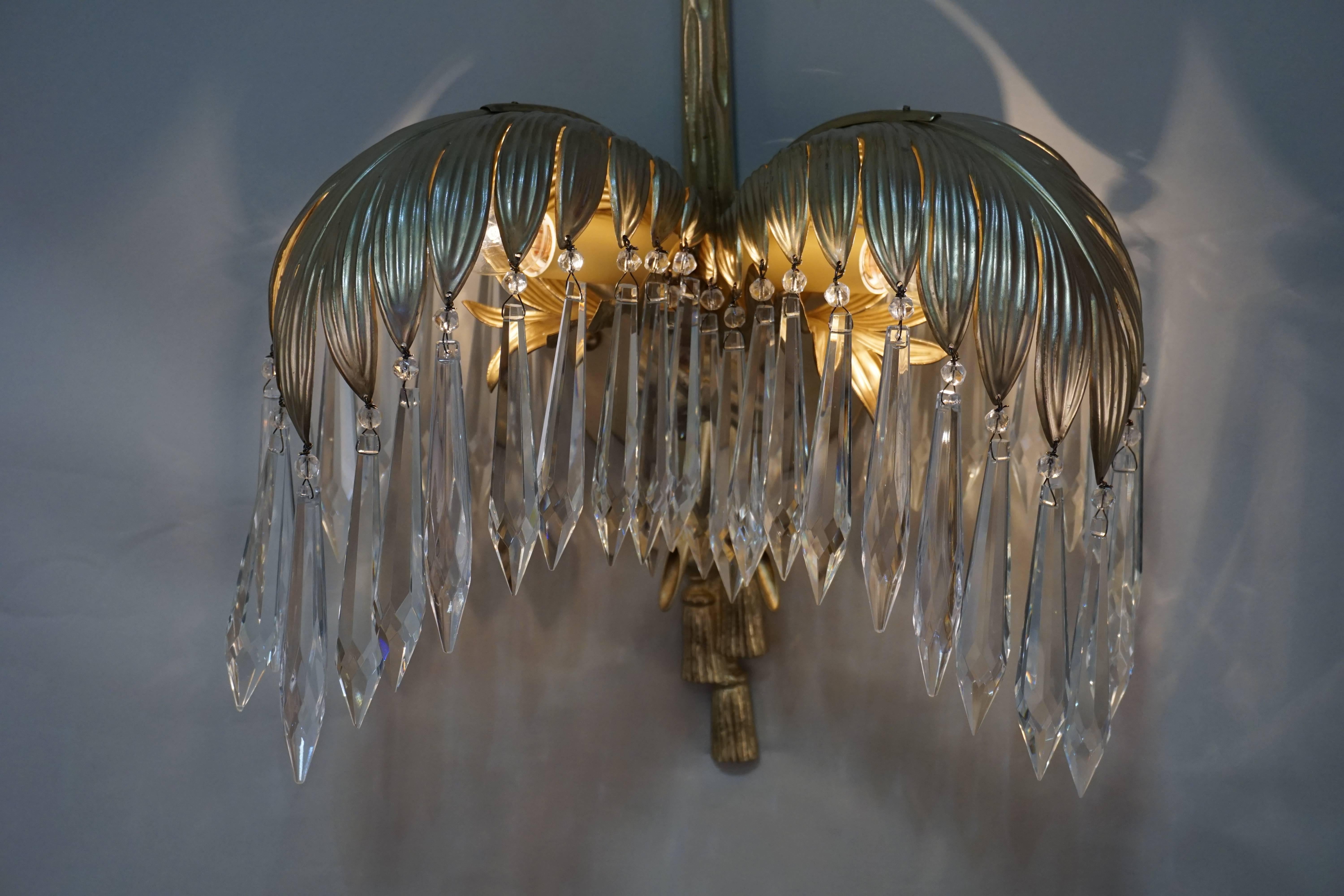 Pair of double light bronze and crystal palm tree wall sconces.