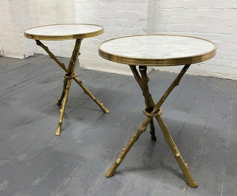 Pair of Maison Baguès style bronze tables white Carrara marble tops. Both tables have bronze faux branch tripod legs.