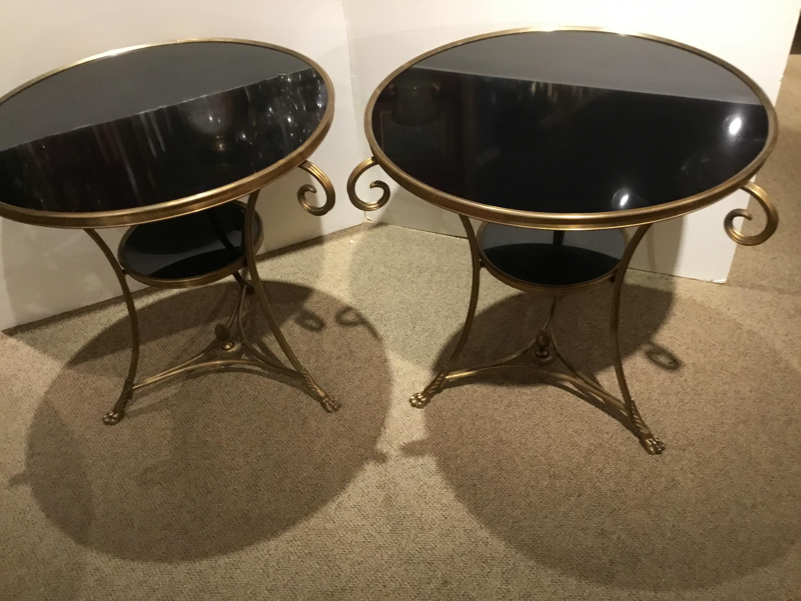 Handsome pair, circular in shape having black marble tops and curved
Legs with a smaller circular marble surface connecting the legs.
Acorn finial is centered at the base and the legs ending in a claw foot.