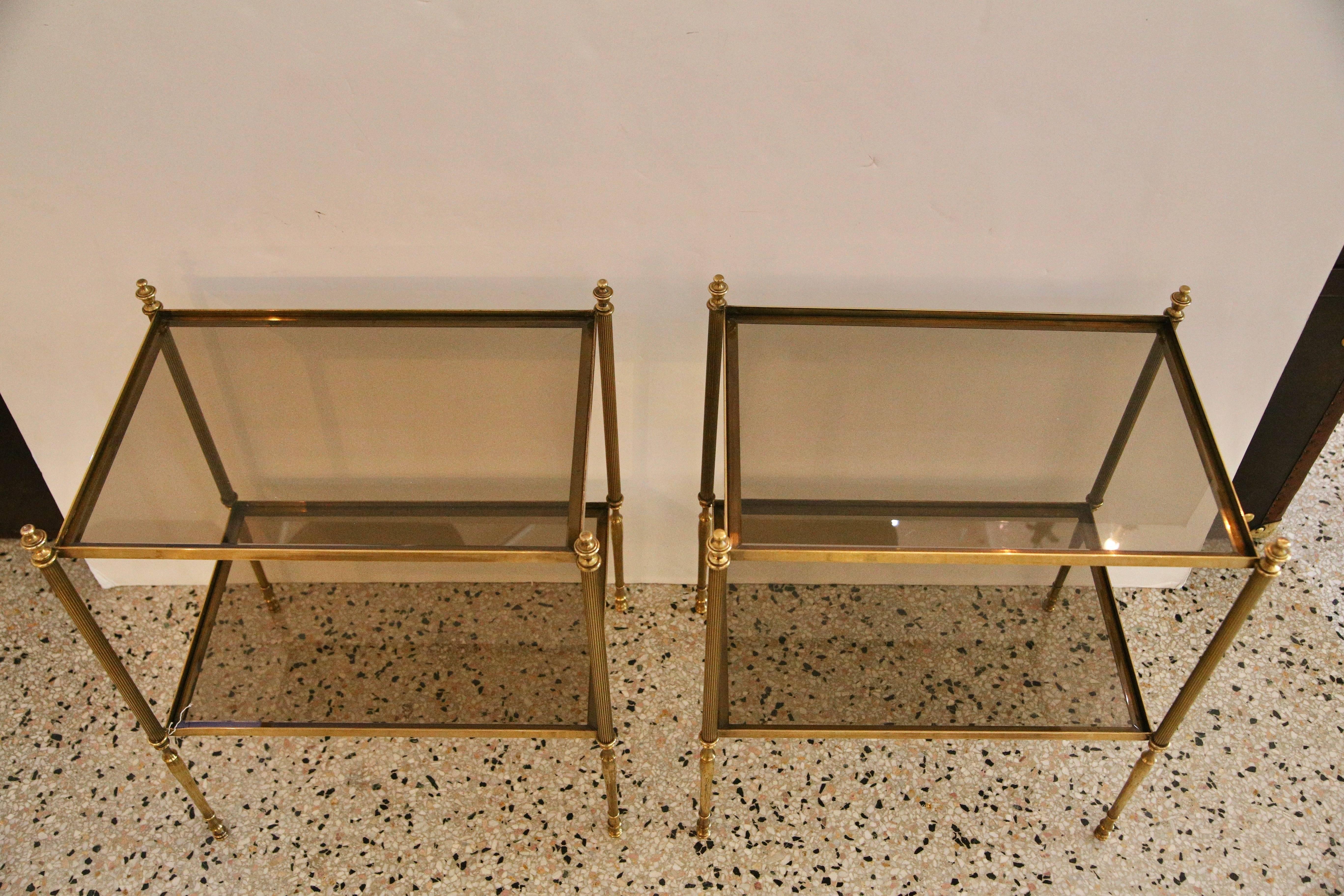 This stylish pair of side tables were recently purchased in London and are in the style of Maison Baguès. The glass has a clear-smokey bronze coloration which compliments the antique brass finish.