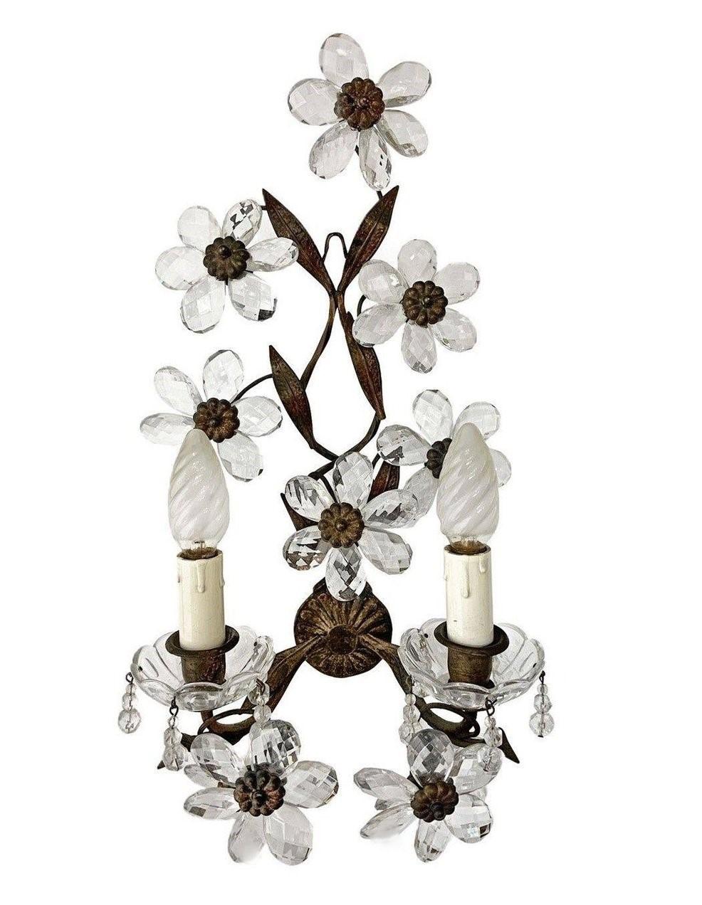 Pair of Maison Bagès gilded wrought iron two-arm wall lights, France, 1920s. Wonderful art environment handcrafted in wrought iron and gilded, enriched with ten clear faceted crystal flowers (each sconce). In very good condition, no damages,