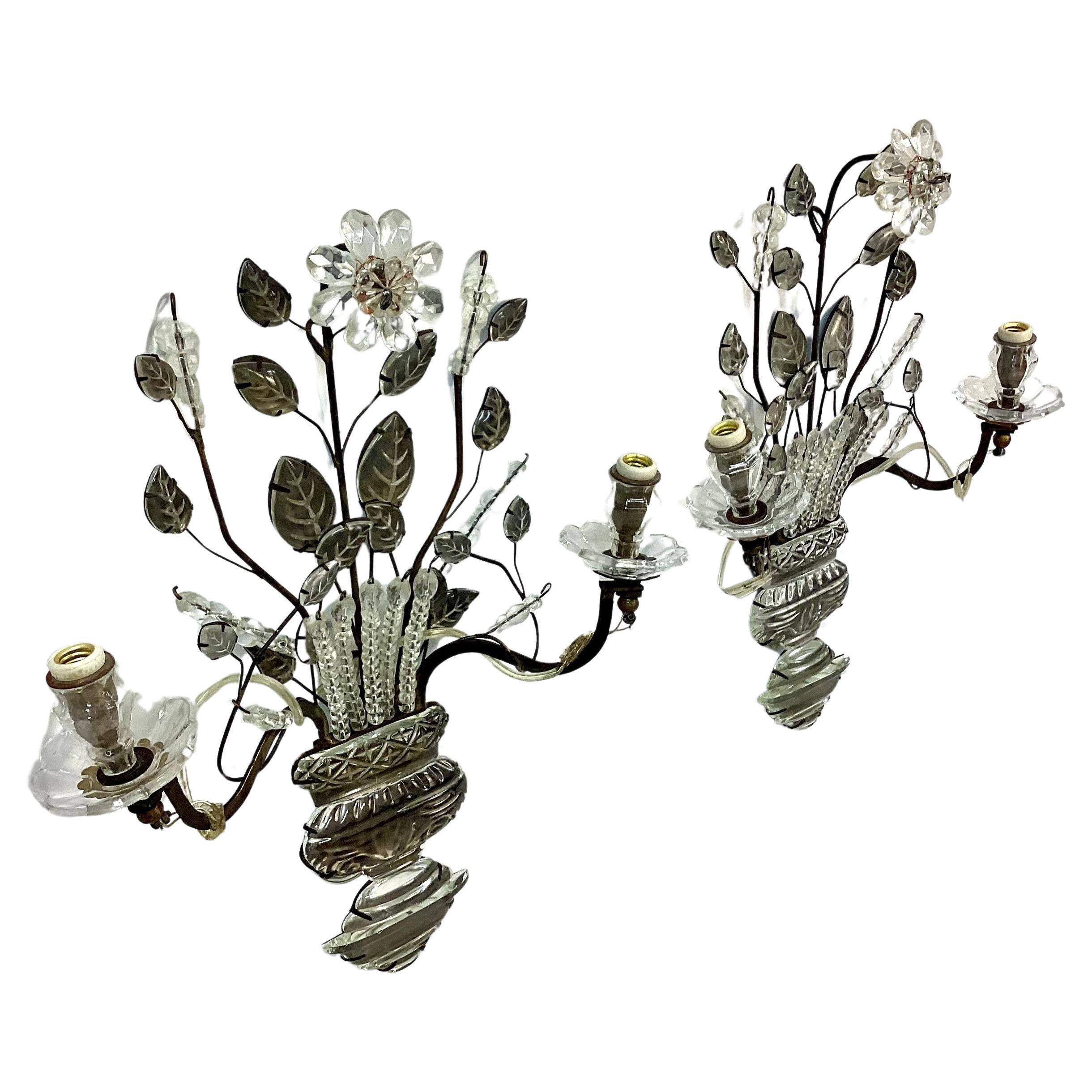 Pair of early 20th century French Maison Baqués  crystal and gilt iron urn form wall sconces. In the shape of bouquets with two lights and floral leaf detail. Includes wires to electrify sconces. Wonderful condition.