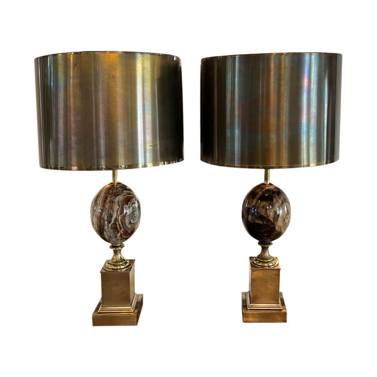 An iconic design by the French lighting designer Maison Charles, this near pair of lamps are stamped with the maker's name (see picture). Amazing quality, handcrafted in France and retaining their original metal shades. 

Please see the pictures