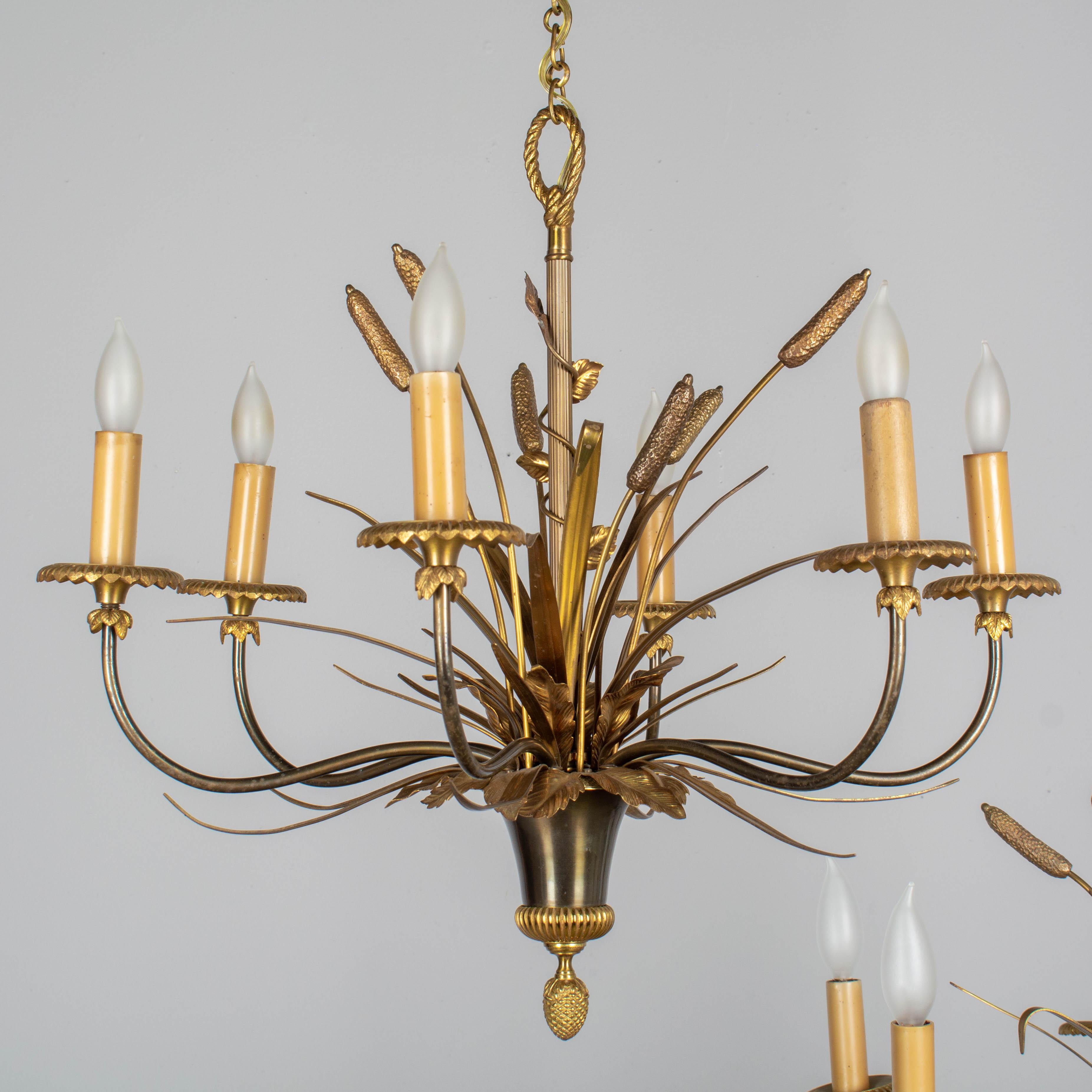 A pair of French Maison Charles doré bronze and patinated brass six-light chandeliers. Exceptional craftsmanship with fine details including six cattail stems with long brass leaves. The arms and coupelle have a darker bronze patina that provides