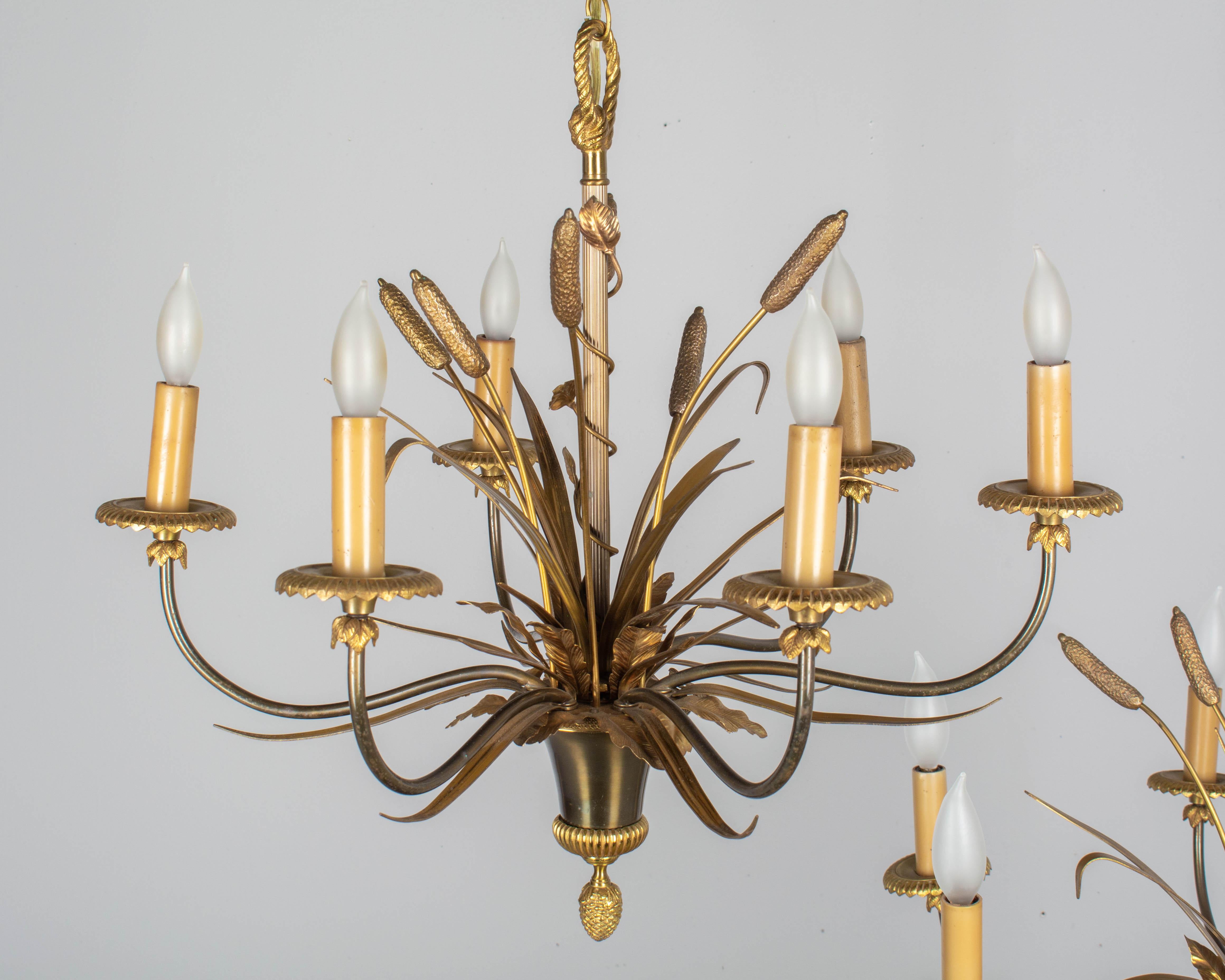Cast Pair of Maison Charles Bronze Chandeliers