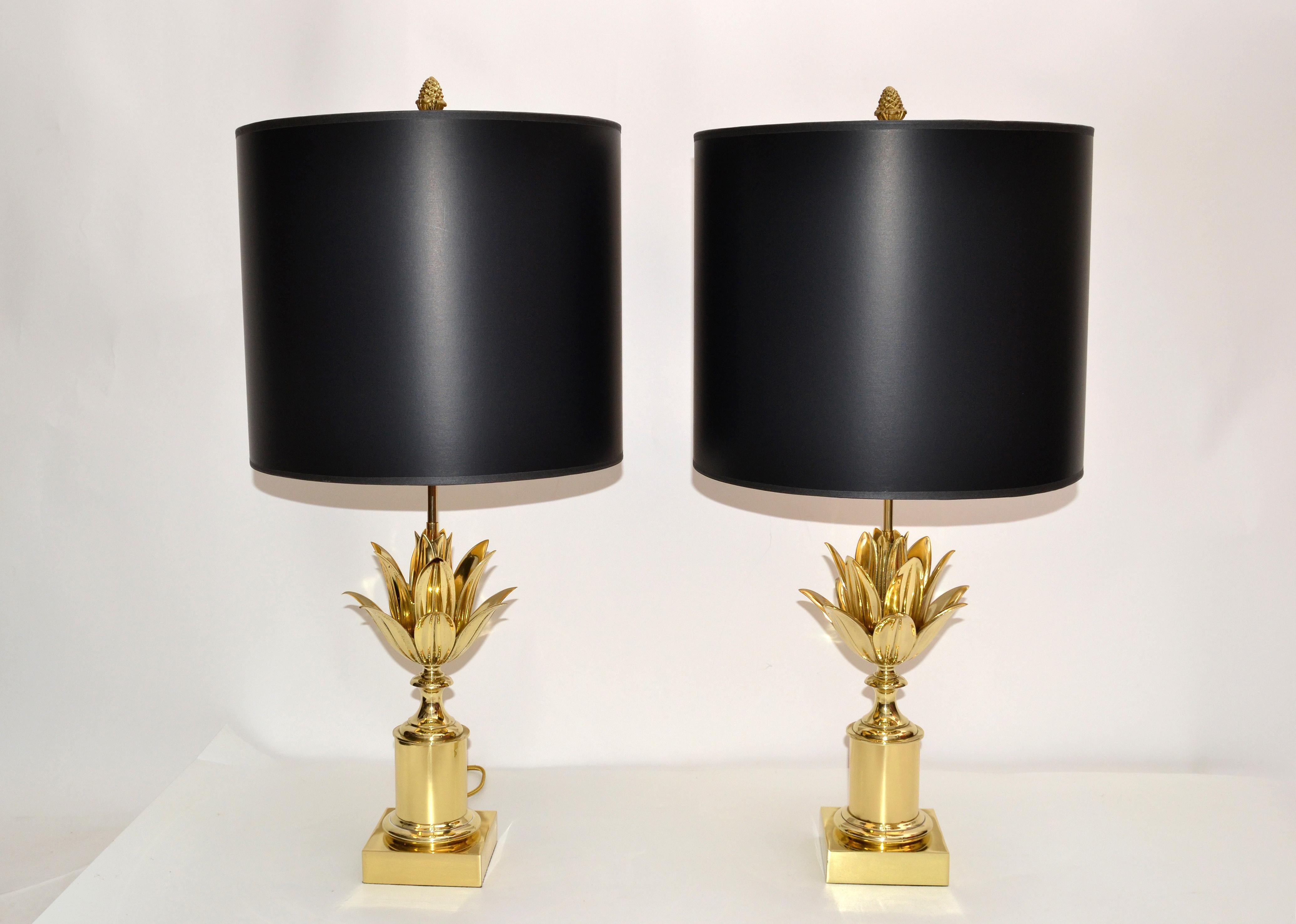 Superb pair of Maison Charles French neoclassical lotus table lamp in solid polished and lacquered bronze.
US rewired with golden Fabric Cord and has in between a transparent Hand Switch.
Each Lamp takes two light bulbs max 40 watts, LED work