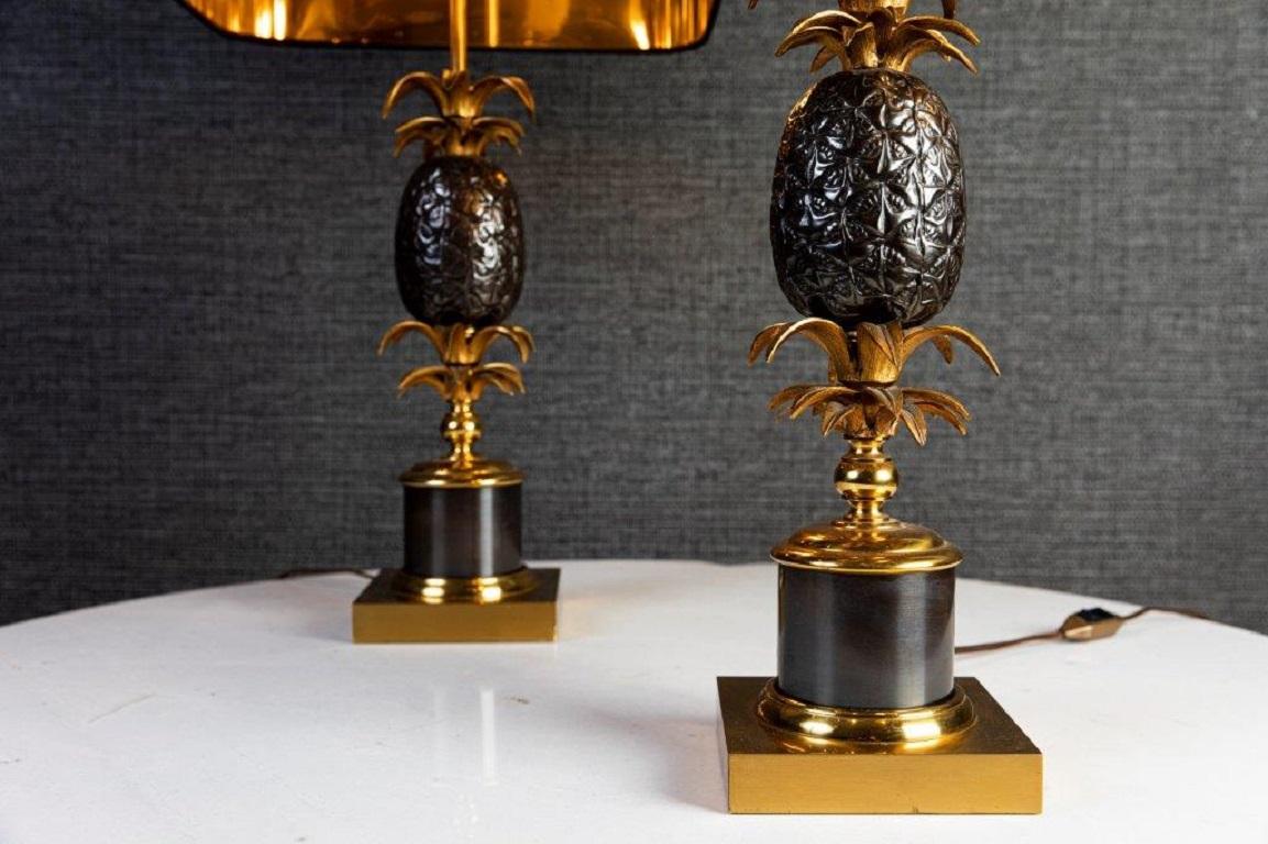 Pair of Maison Chales brass table lamps with two-tone lampshade: black outside and gold inside. From Paris.