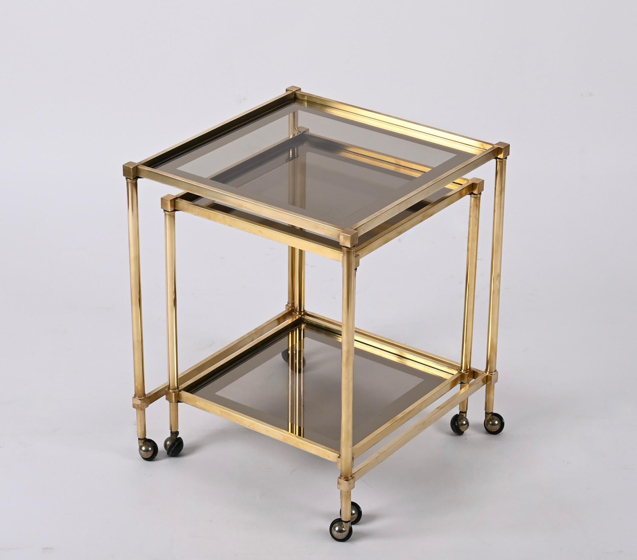 Late 20th Century Pair of Maison Jansen Brass Mirrored Border Nesting Tables with Glass Top, 1970s For Sale