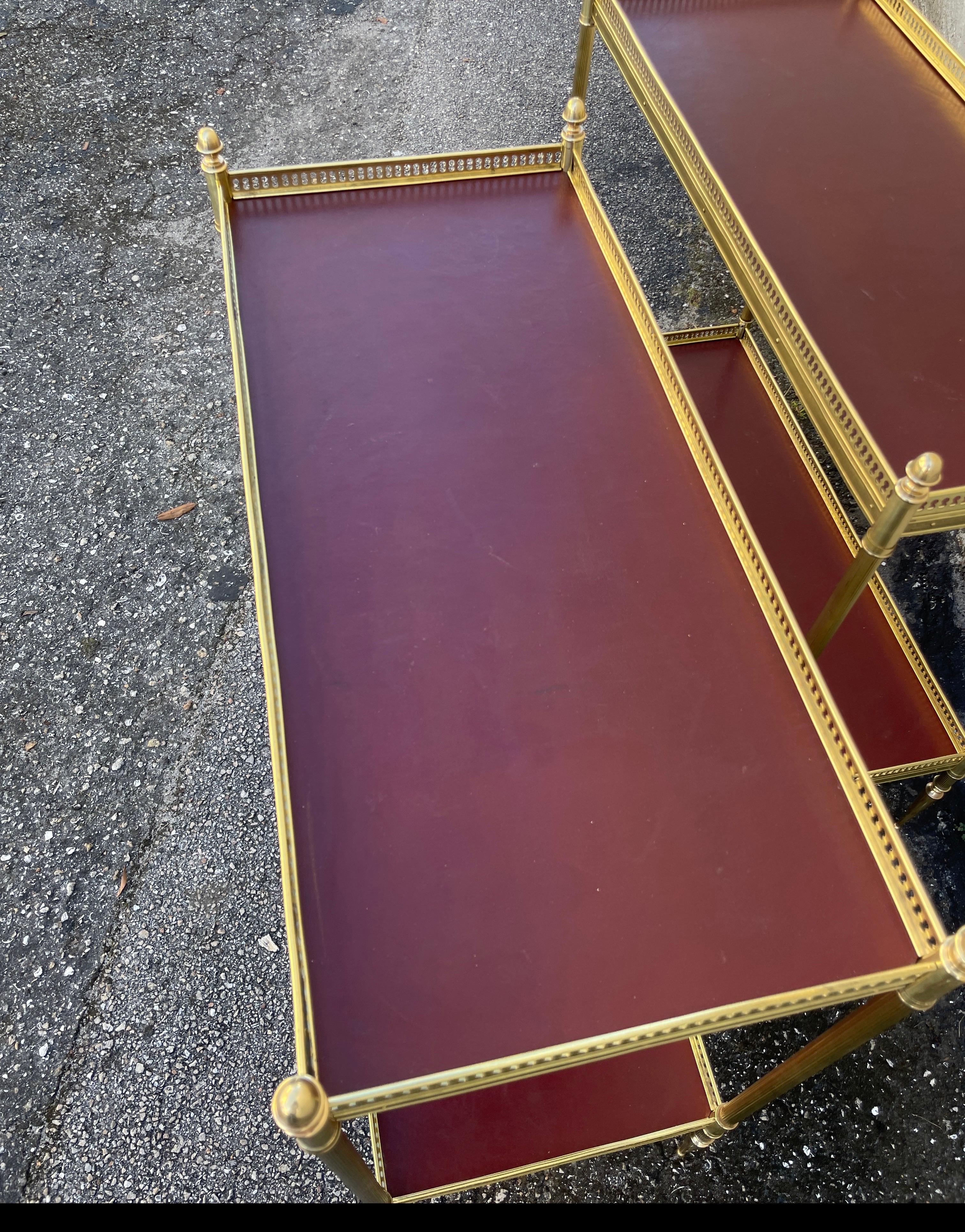 Pair of Maison Jansen Brass & Red Leather Two-Tiered Side Tables In Good Condition In West Palm Beach, FL