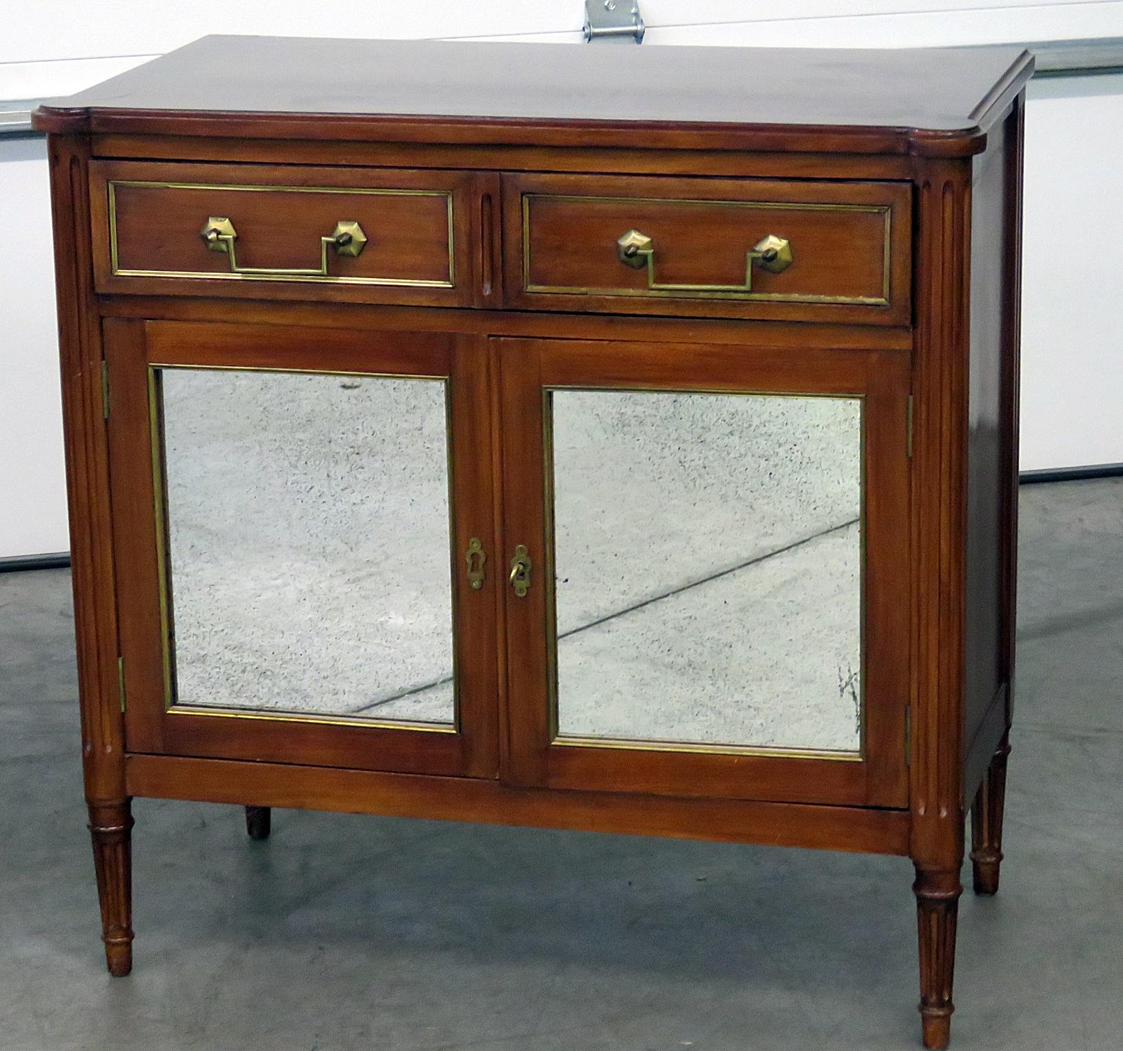 Pair of Maison Jansen Directoire style cabinets with one drawer over two doors containing one shelf and bronze monts.