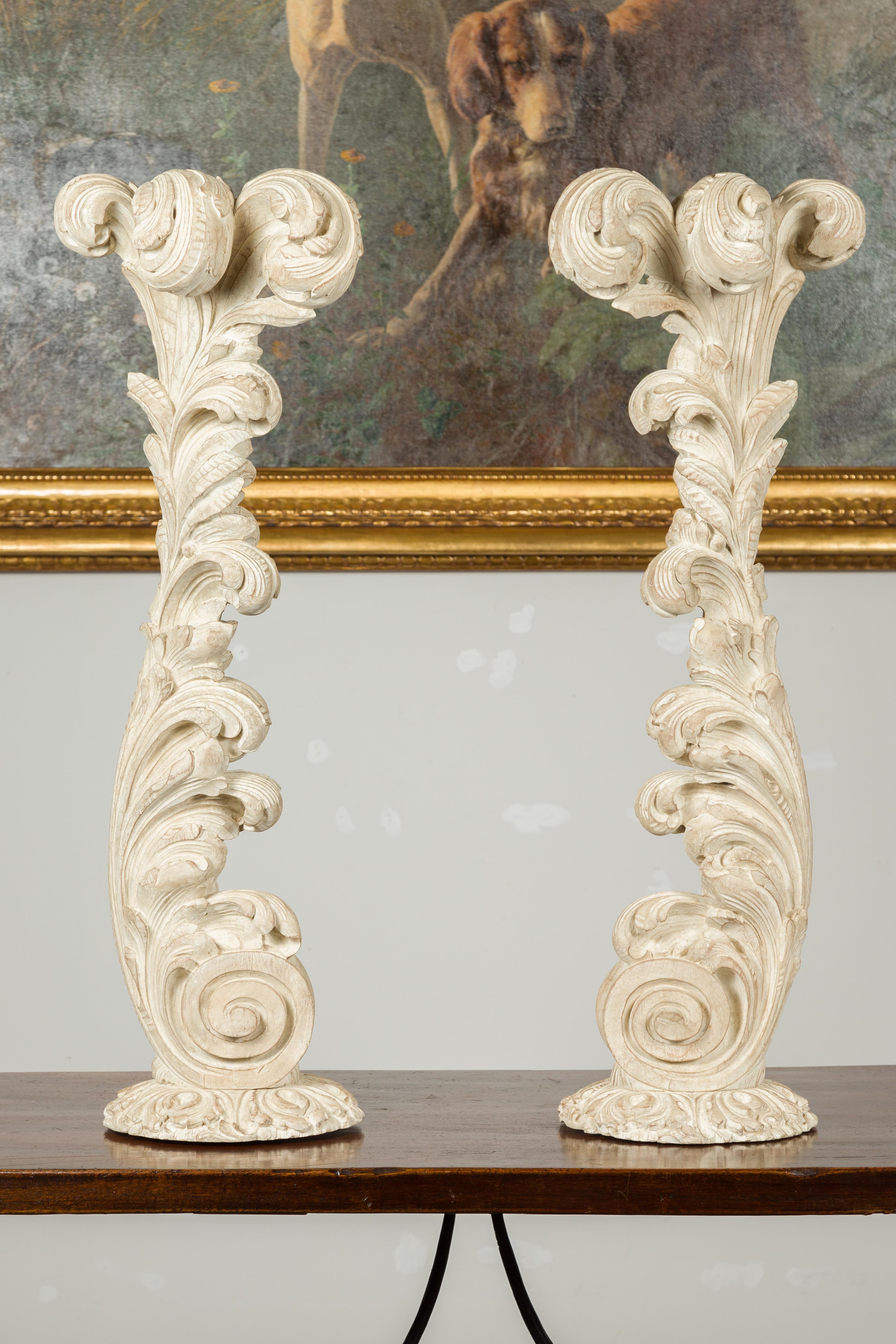 A pair of Maison Jansen carved wooden fragments from the mid 20th century, depicting scrolling foliage on circular base. Created in France by Maison Jansen during the second quarter of the 20th century, this pair of large wooden fragments charms us