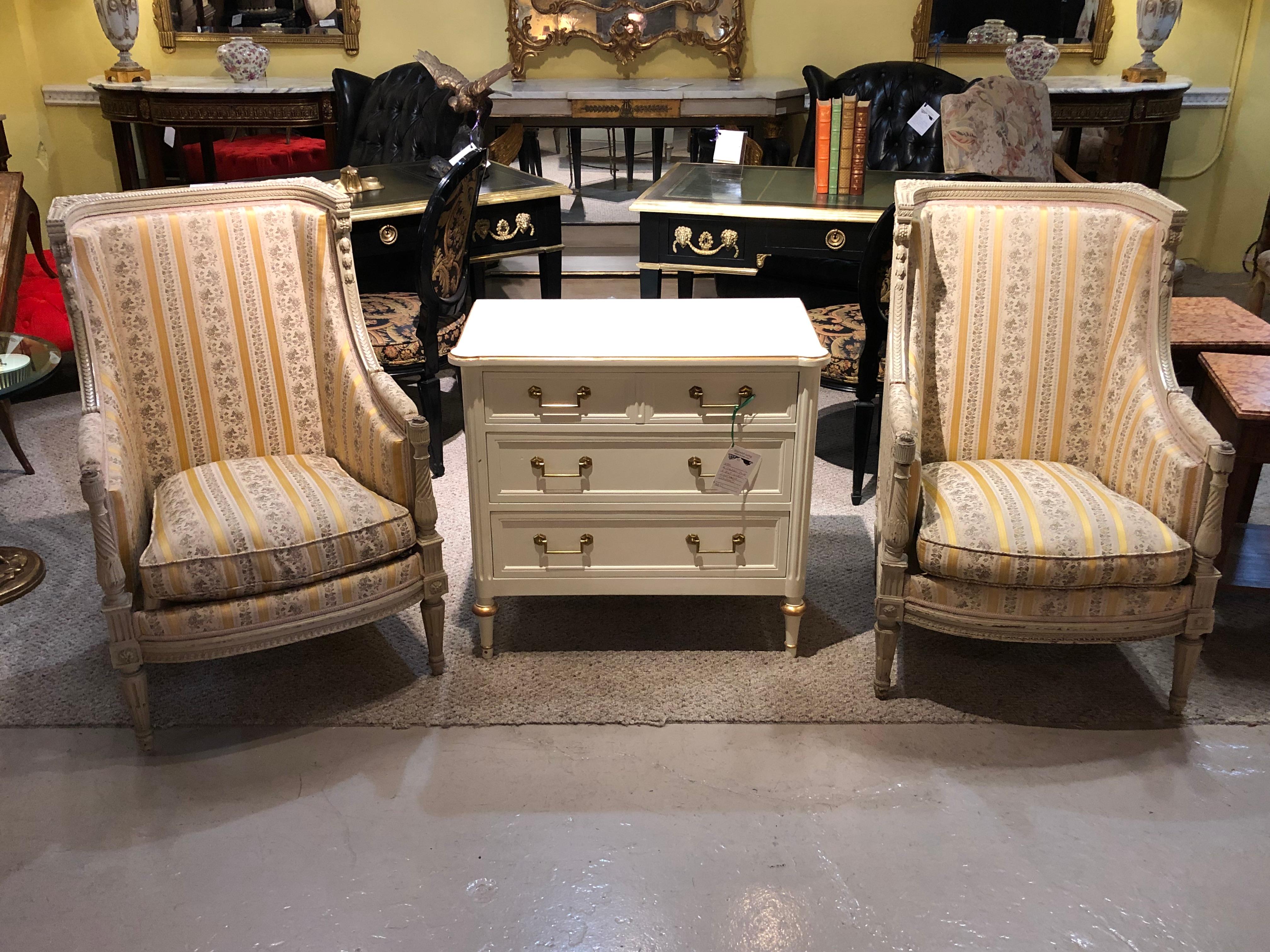 Pair of Maison Jansen attrib. Louis XVI Style French wingback or armchairs in a Swedish Finish. These tall and sleek impressive arm or office chairs are simply stunning depicting the finest quality carvings on the Swedish off white paint decorated