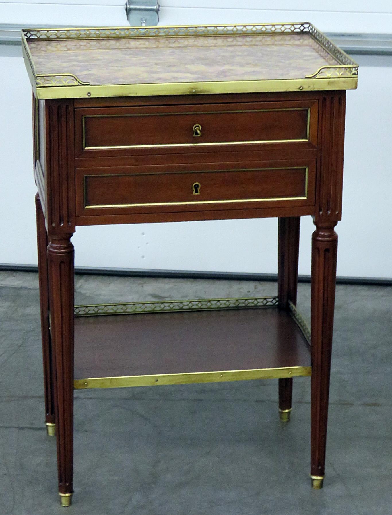 Pair of Maison Jansen Louis XVI style marble top two-drawer end tables with brass mounts and gallery.