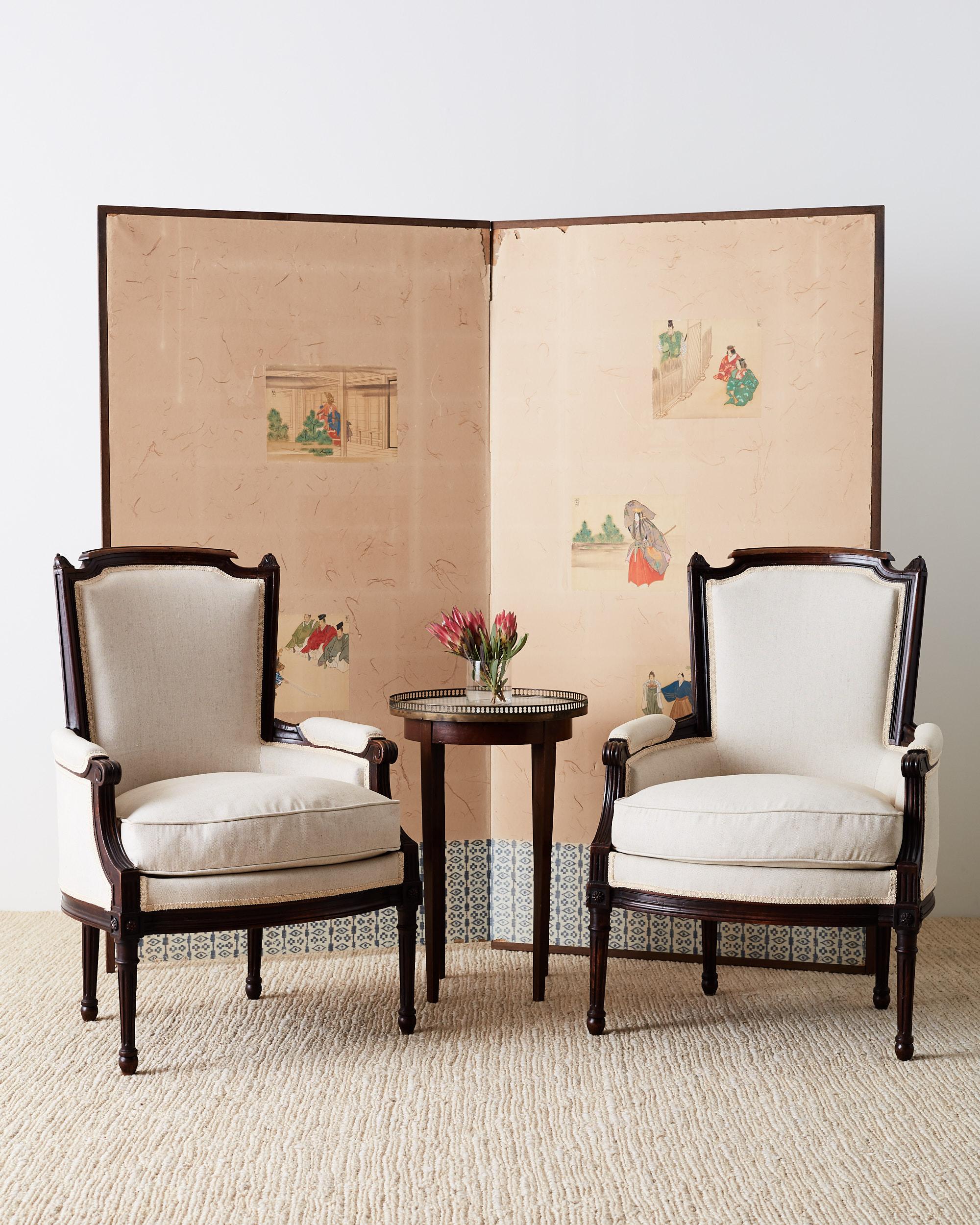 Restored pair of Maison Jansen walnut bergères made in the French Louis XVI neoclassical style featuring new French linen upholstery. These chairs are stunning with cream colored linen with a lovely texture that showcases the dark walnut frames. The