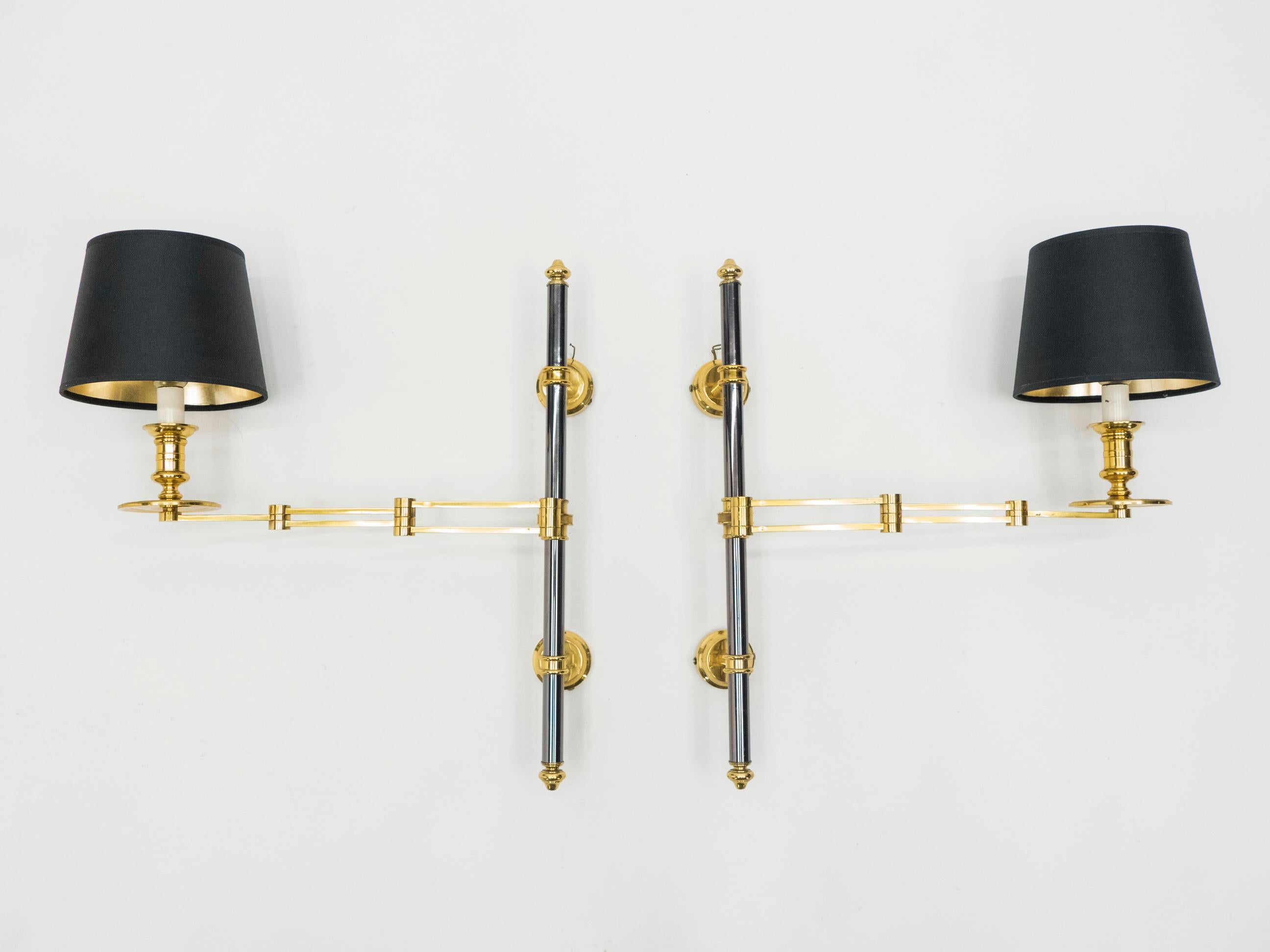 This pair of 1960s sconces is made from Industrial-feeling gunmetal steel and shining brass. The sconces were designed by Maison Jansen, the infamous French furniture design house and they display the typical Maison Jansen neoclassical look, with