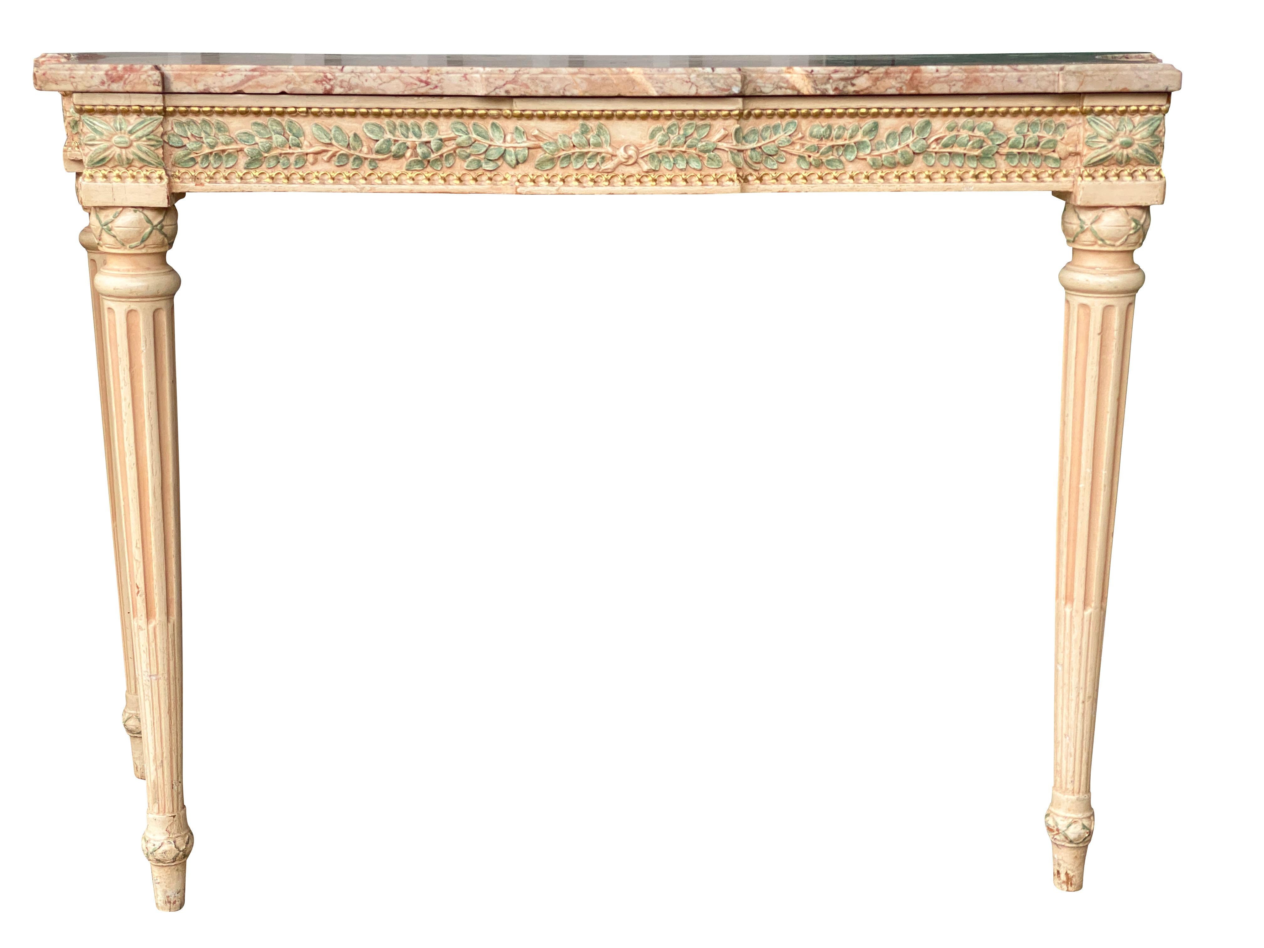 With shaped rectangular marble tops and conforming carved frieze decorated with green painted laurel leaves and gilding, raised on circular tapered fluted legs. Original furnishings from the Waldorf Astoria Hotel circa 1931. With original labels.