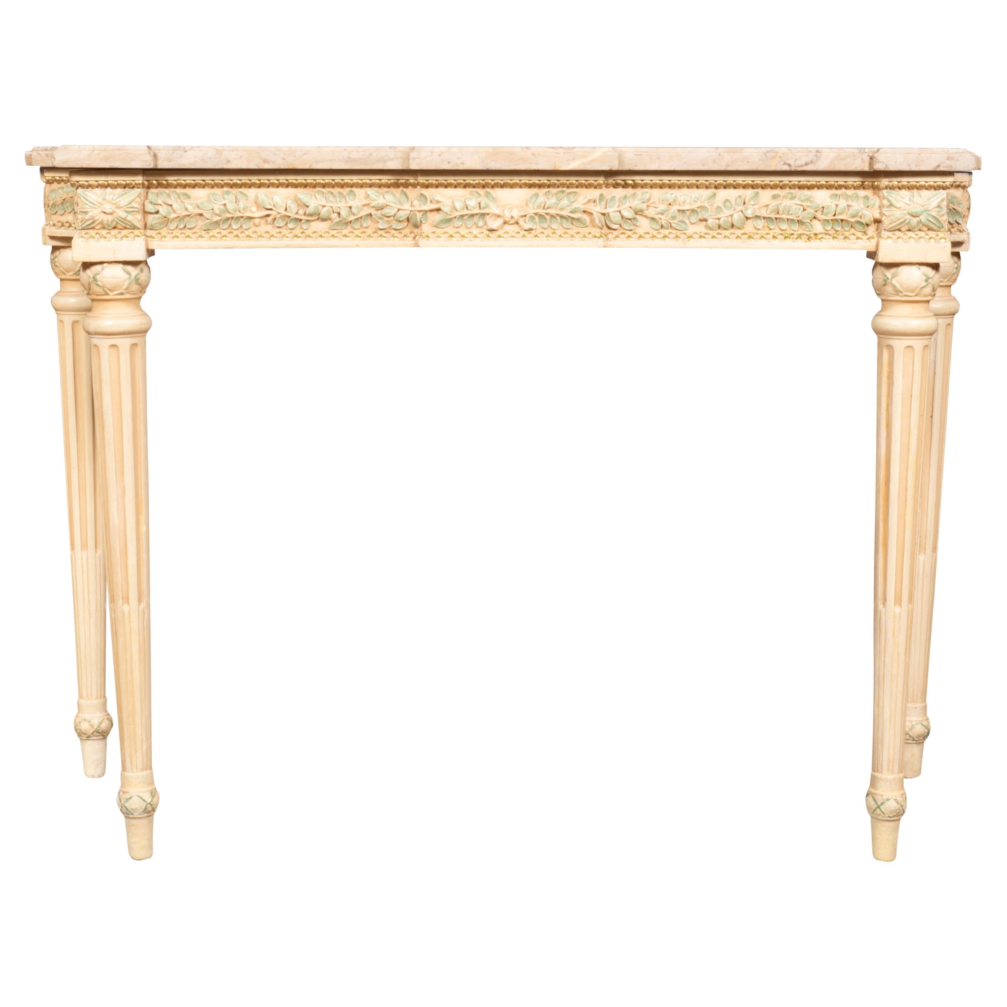 From the Waldorf Towers original furniture with tags labelled Waldorf Astoria. With  well matched original marble tops over a frieze decorated with green painted laurel leaves with subtle gilded beading. Circular tapered fluted legs. This table