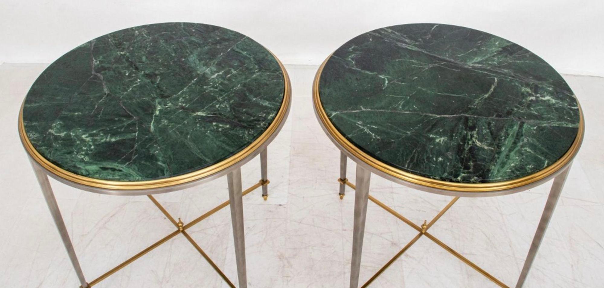 Pair of side tables by Maison Jansen, made in the 1970's, made with molded brass frames supported by steel resting on four square steel legs connected by a brass X-form stretcher. Topping each table is a round piece of Verde Antico marble, which