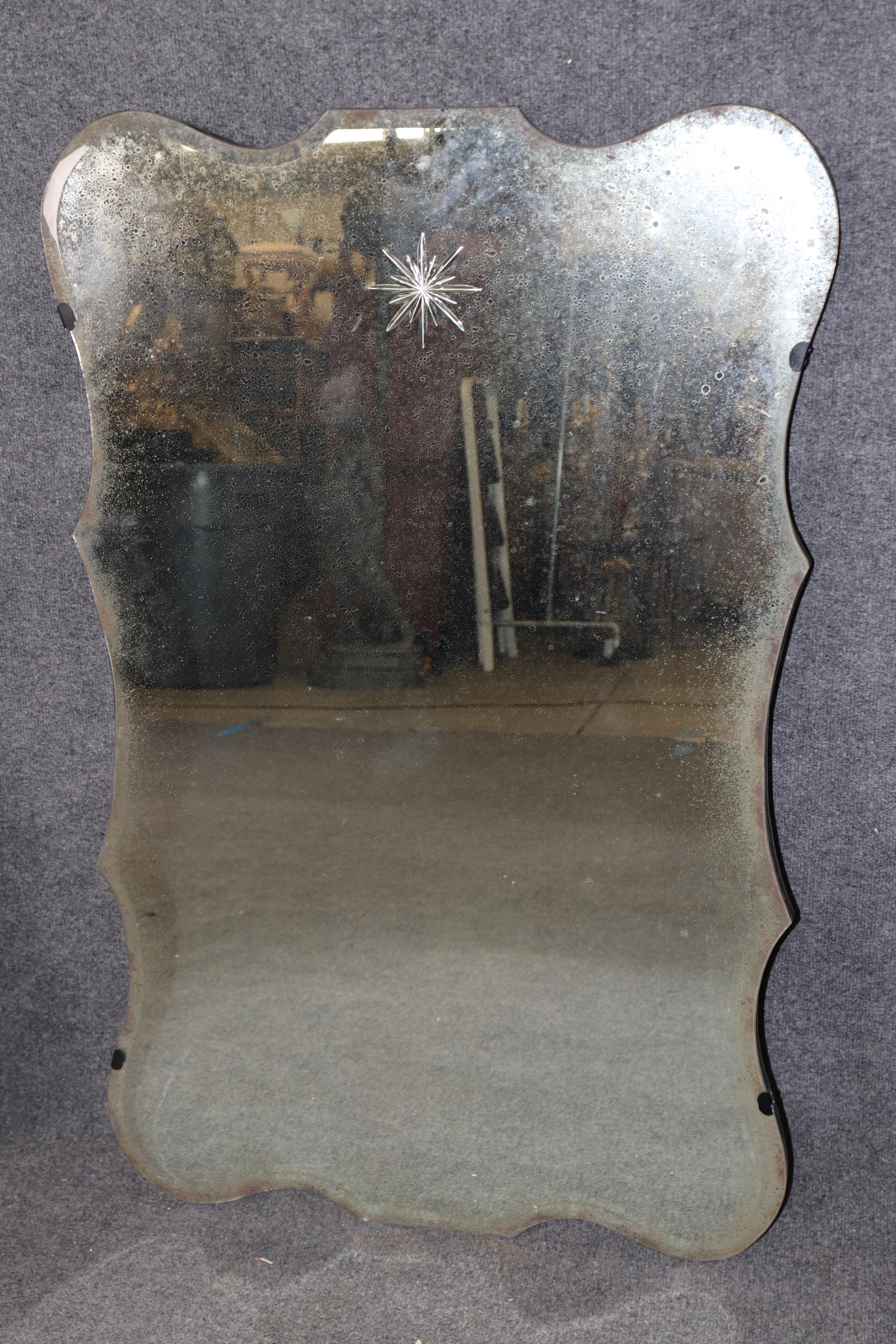 This amazing pair of acid etched and cut etched star mirrors in the style of maison Jansen and Hollywood Regency are absolutely gorgeous. They are in good condition with a minor small defect here or there but still bold and quite striking. They are
