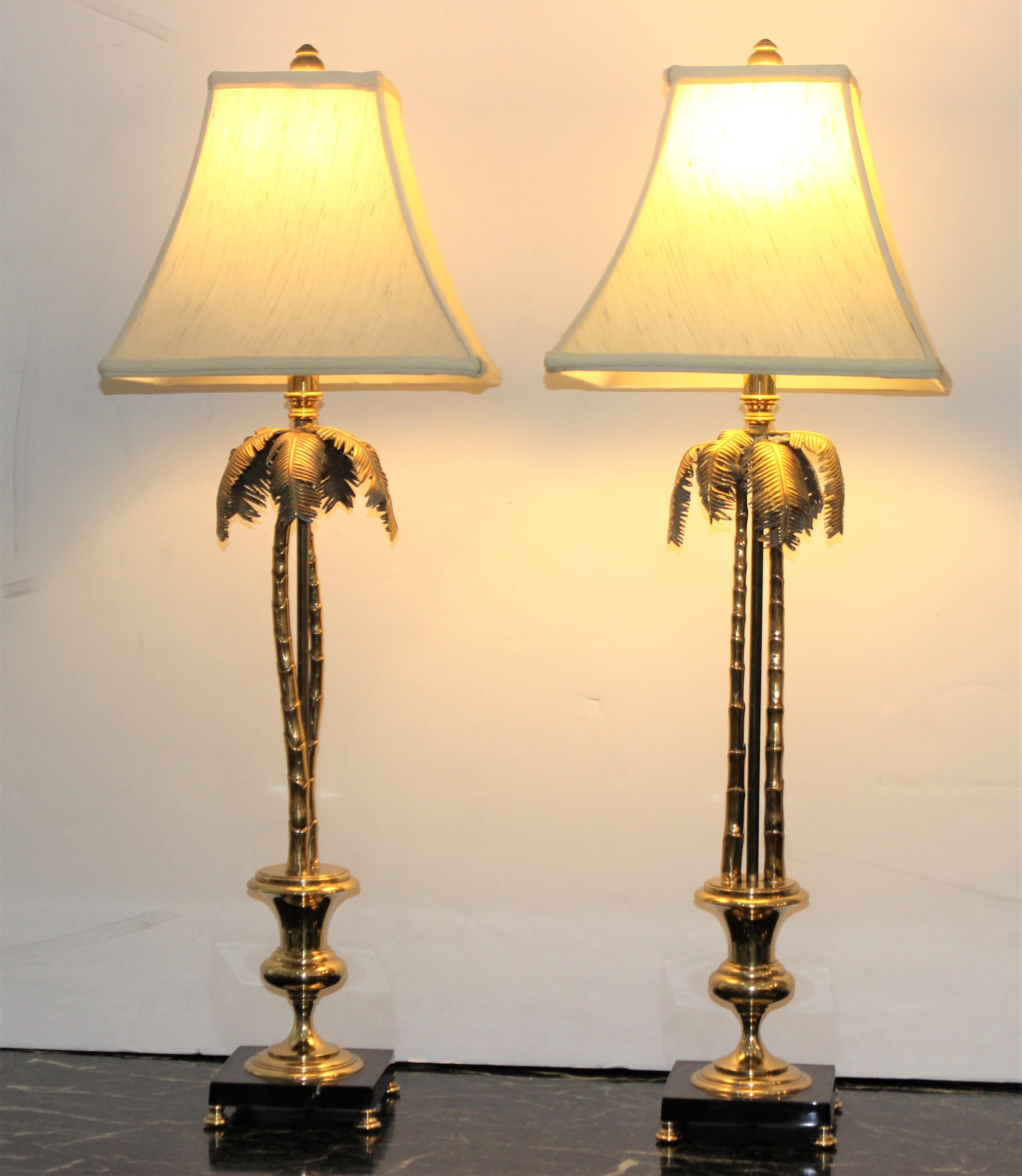 This stylish and chic pair of brass palm tree form table lamps are very much in the style and quality of pieces created by Maison Jansen in the 1960s and 1970s. 

Note: Base is a faux marble enameled finish.

Note: Base of lamps dimensions are 5.50