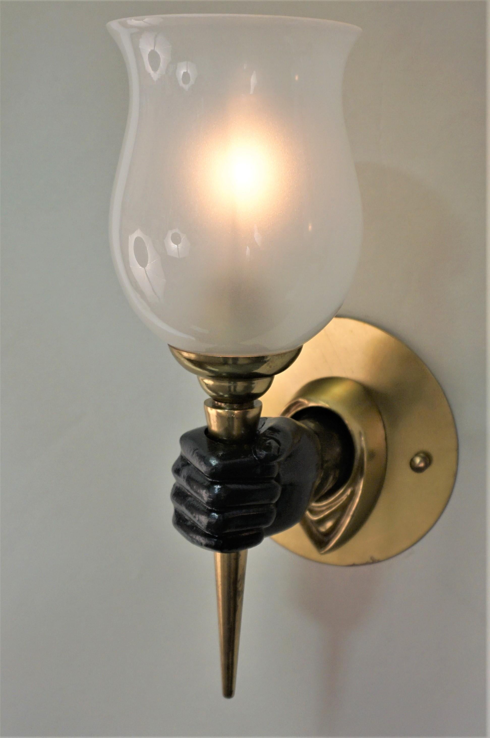 Elegant pair of bronze with black lacquer hand wall sconce with original glass shades.
Measures: Depth 7