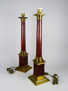 Pair of Maison Jansen style column lamps in red-painted brass, mid-20th century.