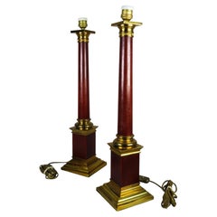 Pair of Maison Jansen style column lamps in red-painted brass, mid-20th century.