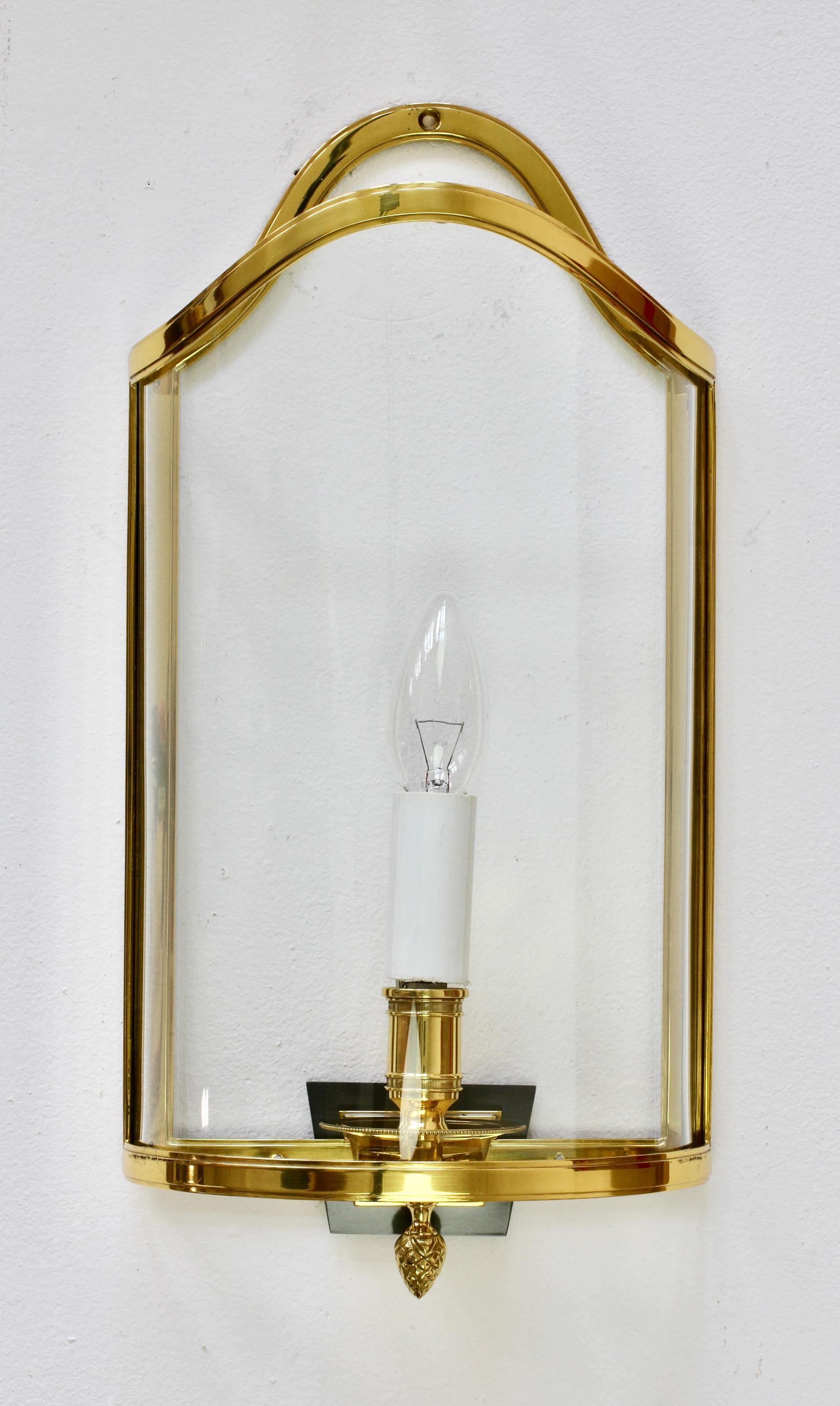 Pair of stunning elegant and large scale vintage midcentury vintage wall lights, lamps or sconces made of polished brass with original curved and cut glass scroll shaped shades by the German united ateliers Vereinigten Werkstätten München (Munich),