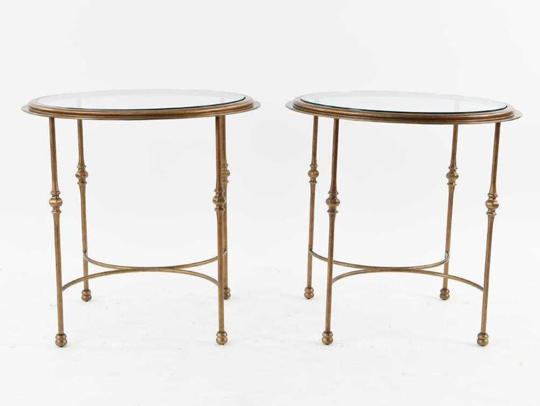 The pair of classical form circular gueridon with inset glass tops are made of patinated bronzed metal. Curved stretchers secure the decorative legs. Perfect as end or side tables for the sun room or porch.
Small chip on the glass top and some