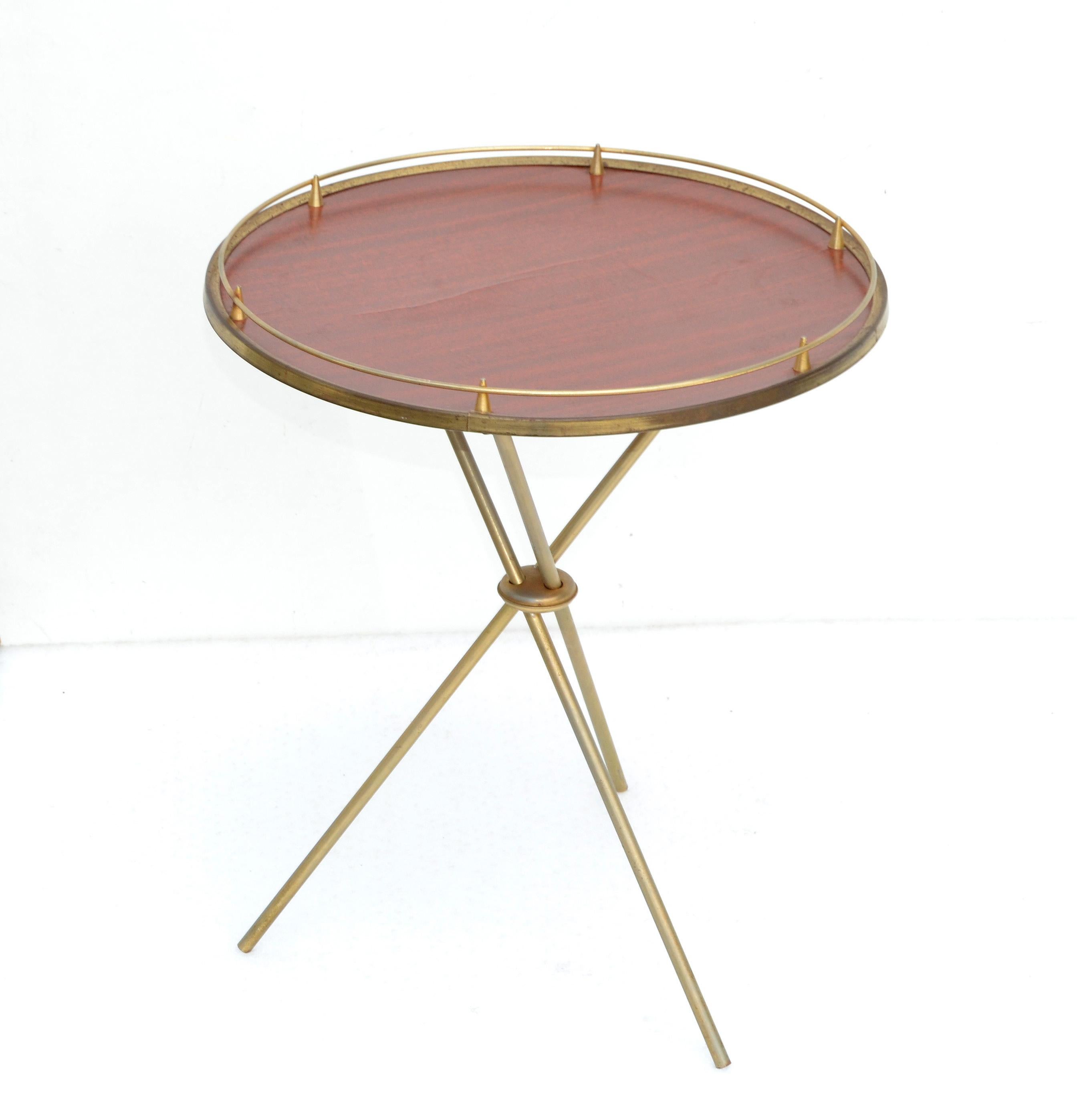 Pair of small round laminated side table by Maison Jansen French Mid-Century Modern circa 1955.
Elegant Gio Ponti Style Tripod Base in Brass and Decorative cast galleries give this piece a neoclassical flair. 
Simply lovely & practical.