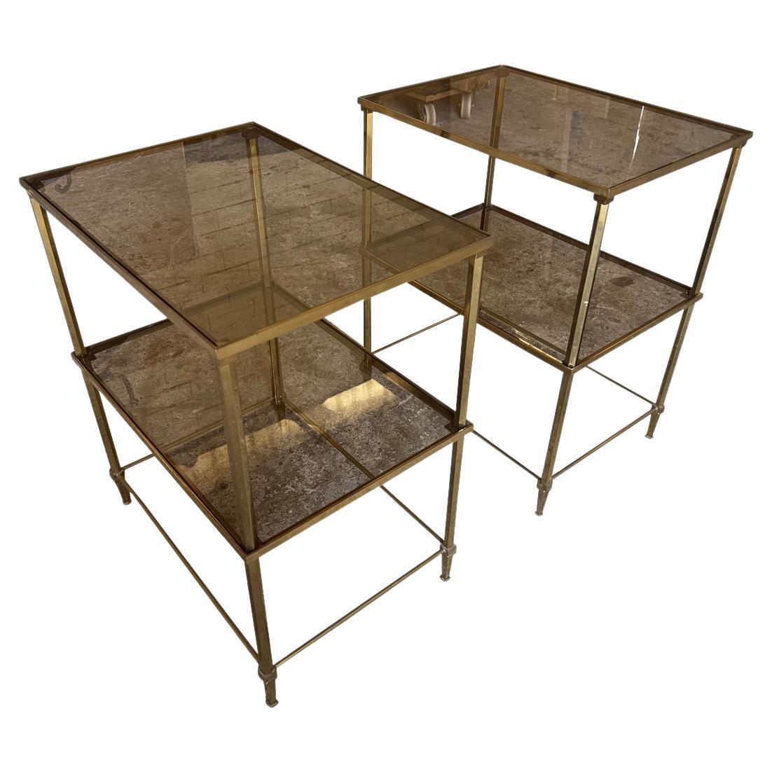 A lovely pair of mid-20th century Maison Jansen style side tables from Paris, France. Nicely constructed from brass and smoked glass. 