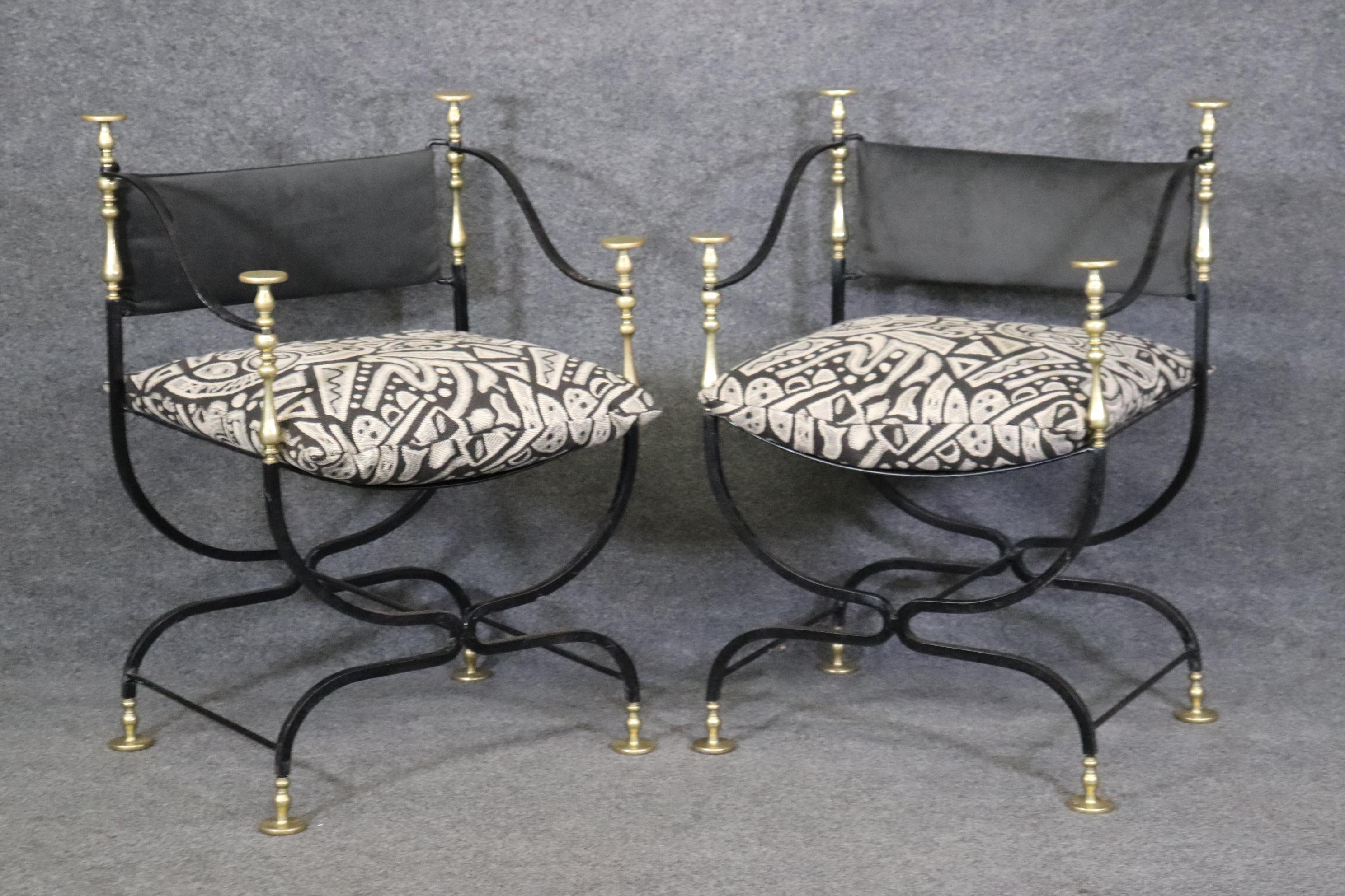 This is a gorgeous pair of beautifully upholstered wrought iron and brass savonarolla chairs with nice newer upholstery and gorgeous details in the metal working. The chairs measure 34.5 tall x 23.5 wide x 21.5 deep and have a seat height of 22.5.