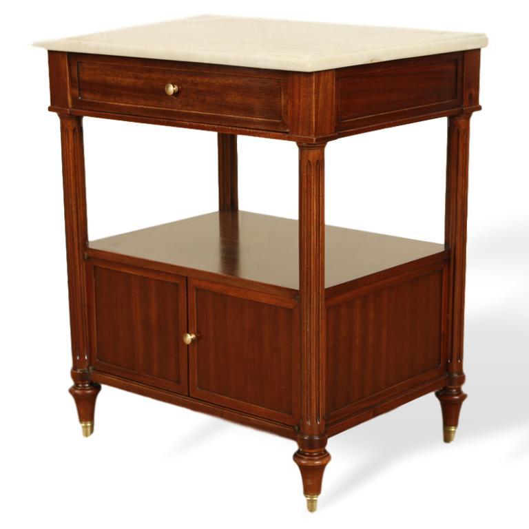 Pair of Maison Jansen two-tier mahogany side tables or cabinets with marble tops, French, circa 1940, each having a single drawer over an open shelve and cabinet doors, on bronze sabots. Exceptional quality. 

Dimensions: Height 24.5
