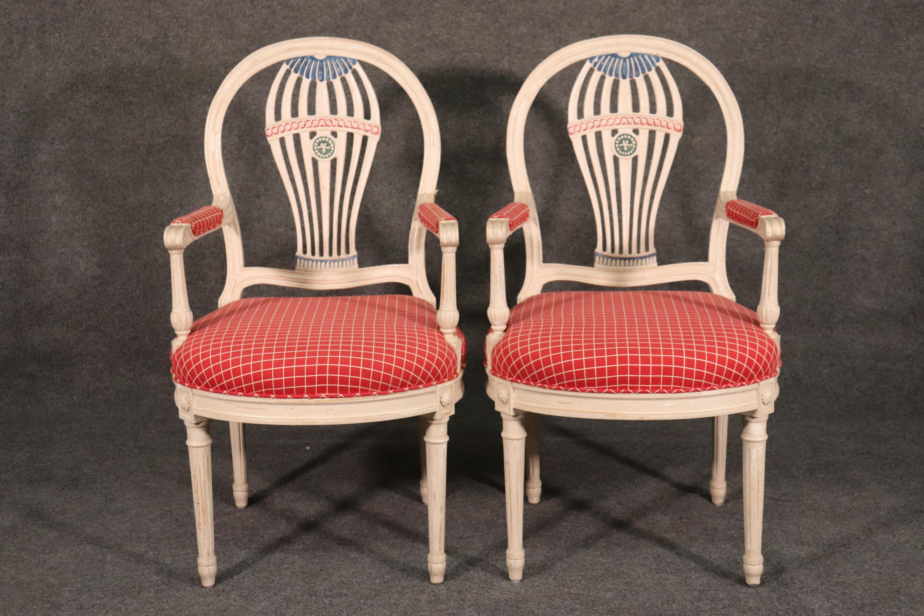 Beautifully hand-painted in Red, blue, white and green, these Maison Jansen chairs can be used at the head of a dining table as head chairs or as armchairs in any room setting. The chairs measure 39 tall x 21 wide x 24 deep and the seat height is 19