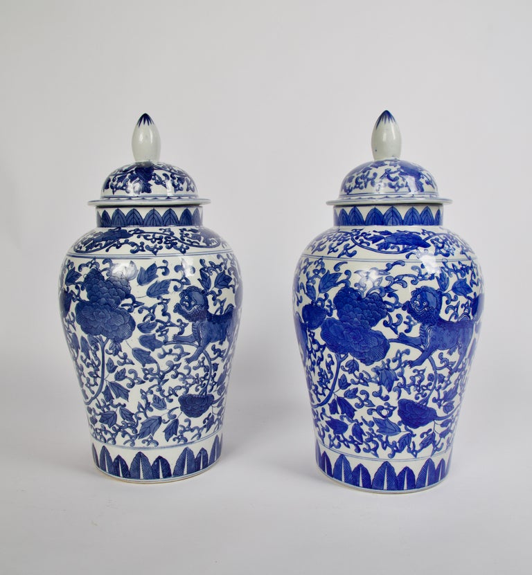 Large pair of Maitland smith blue and white Chinese porcelain ginger jars. Hand painted with foo dogs, a mythical creature surrounded by peonies a symbol of feminine beauty with the body of the vessel painted in an Asian floral and fauna
