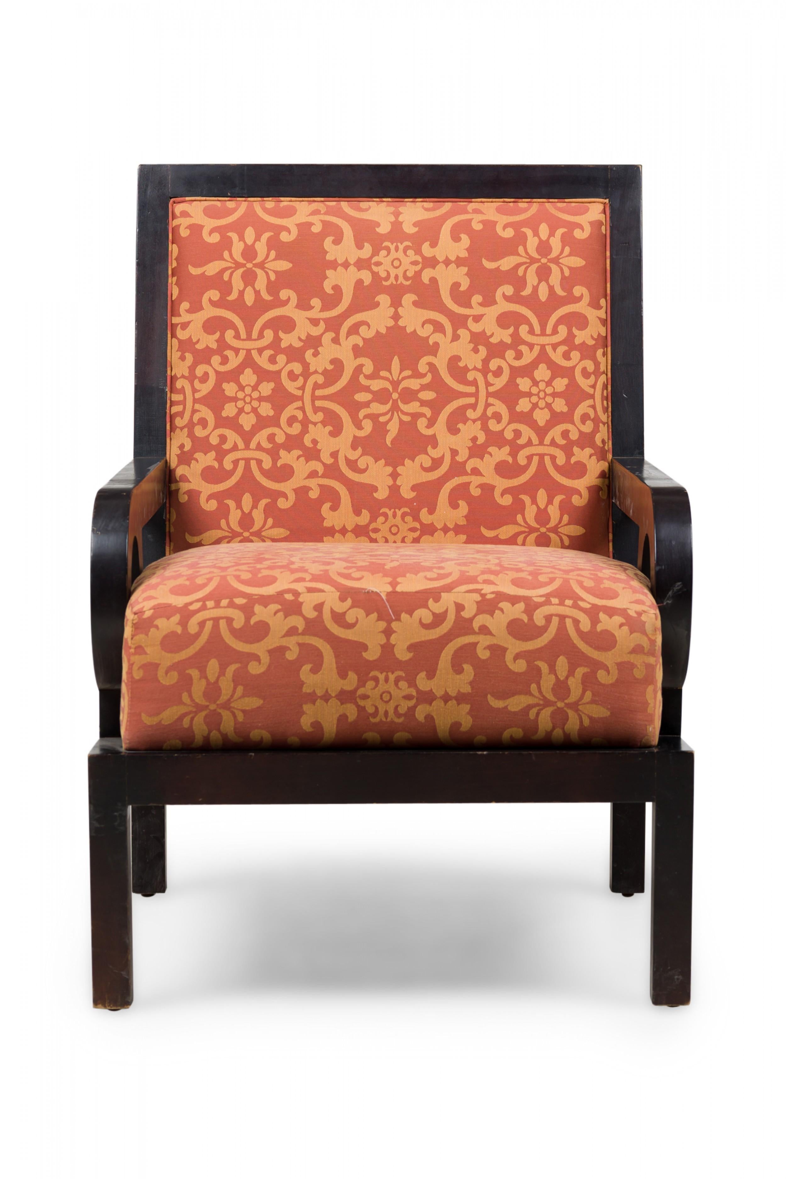 PAIR of midcentury English oversized club / armchairs with dark finished walnut frames with square backs and armrests with circular cutouts, upholstered in a rust orange and gold patterned damask fabric. (Maitland-Smith) (PRICED AS PAIR).