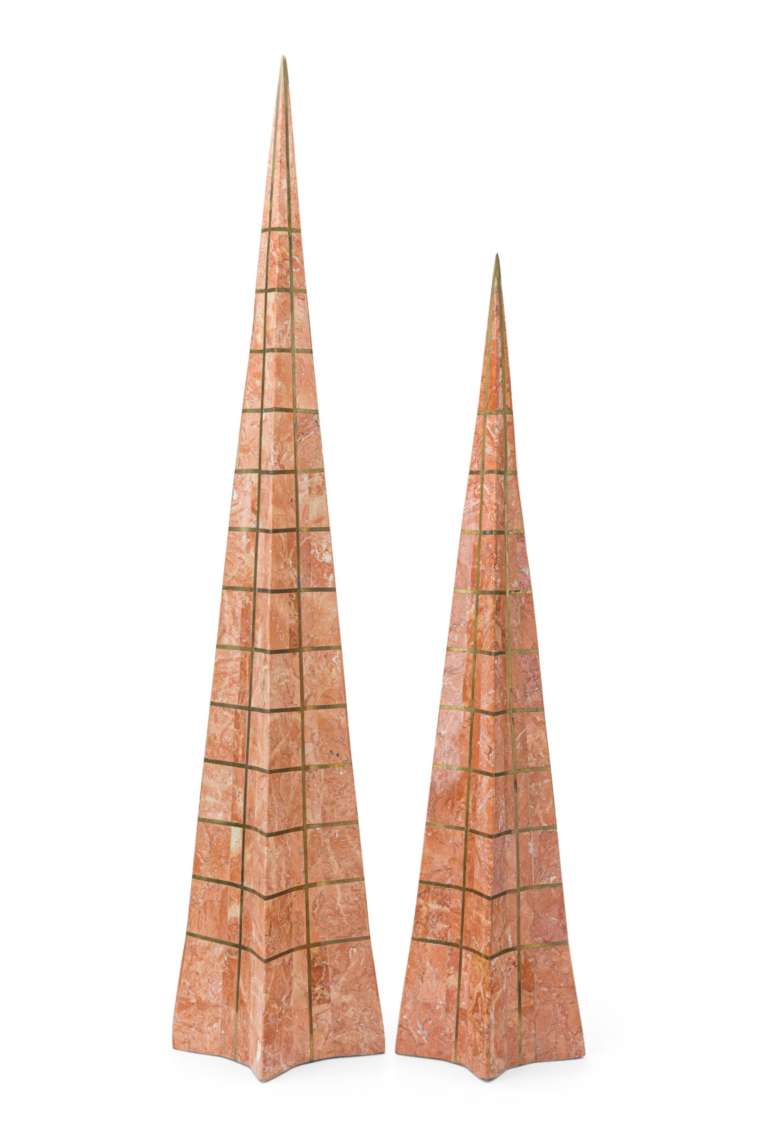 Pair of Mid-Century staggered height obelisks with blush marble exteriors with a brass grid inlay. (ROBERT MARCIUS FOR CASA BIQUE, PHILIPPINES)(PRICED AS Pair)

Taller obelisk: 34