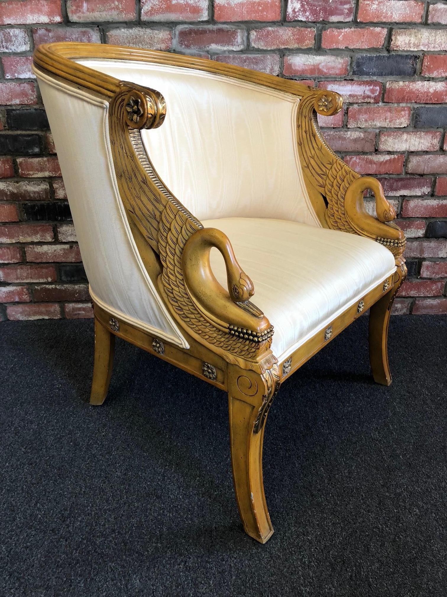 A pair of hand-carved mahogany empire armchair with gold metallic leaf swan accents and light yellow moire silk fabric by Maitland-Smith, circa 1980. 

Measures: Arm height is 30.5