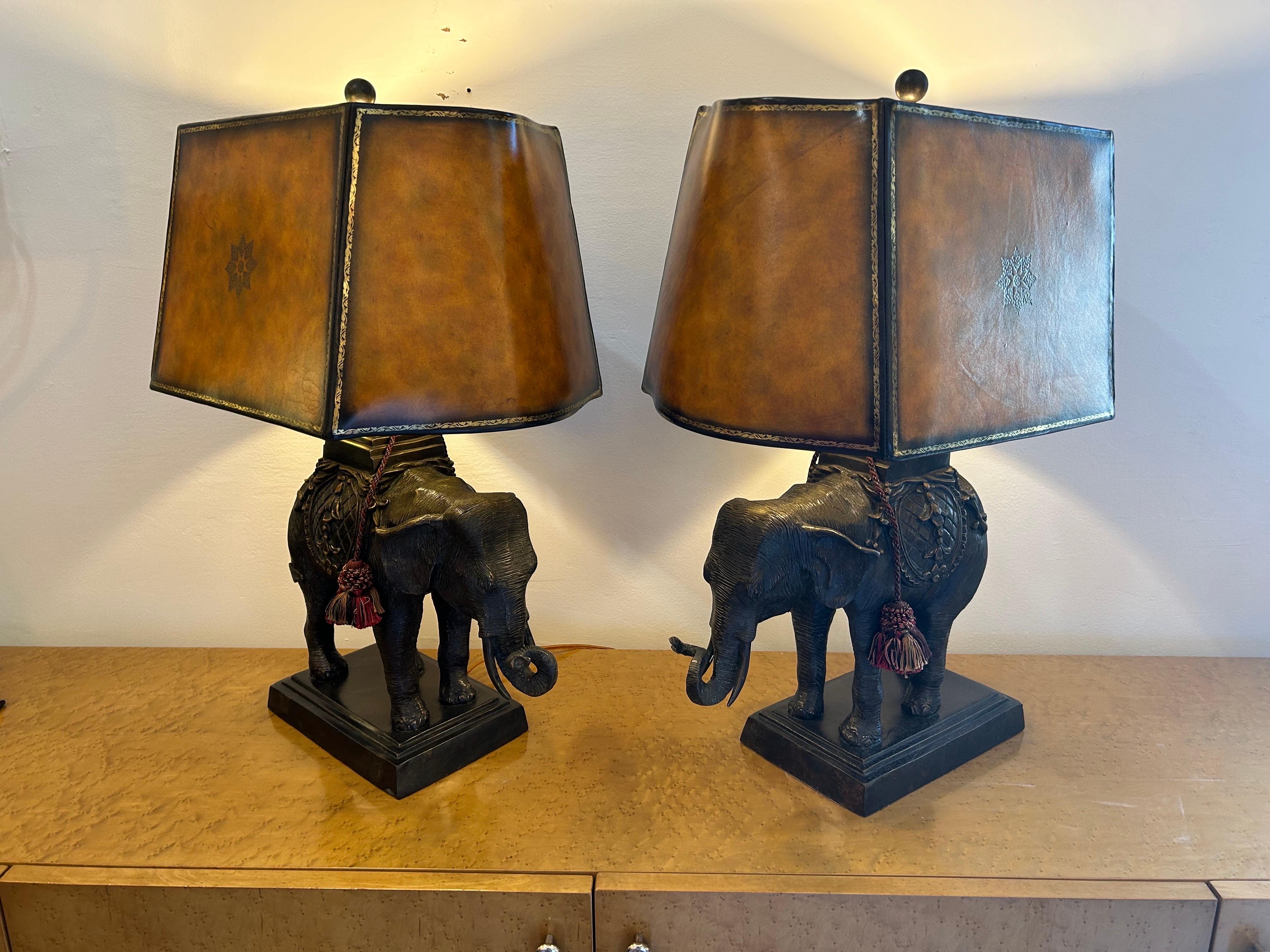 A pair of Maitland Smith bronze elephant lamps with their original leather shades in showroom condition