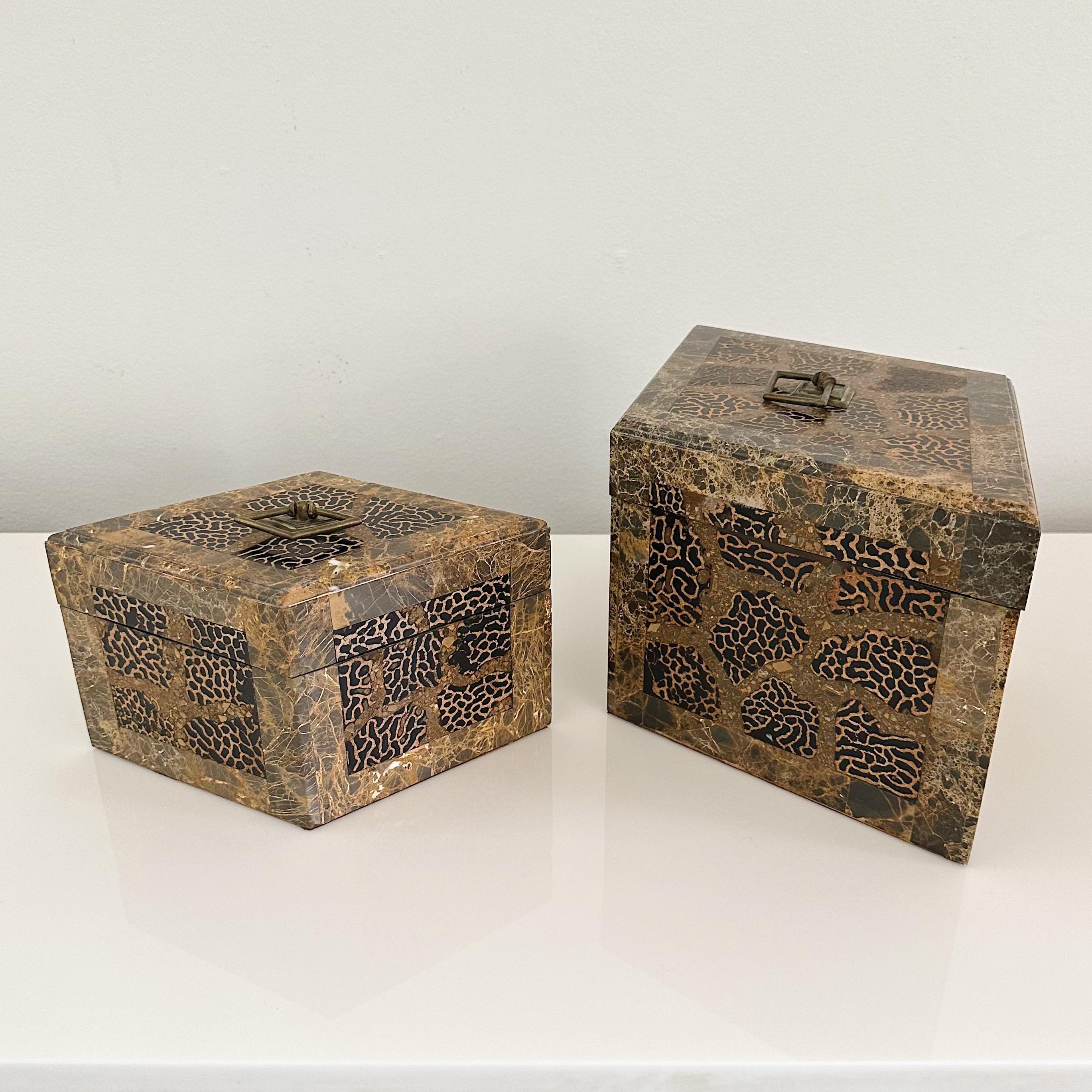 Maitland Smith pair of captivating duo of animal print design marble and tessellated lidded nesting boxes. This exquisite set comprises one larger box and one smaller box.

Each box is adorned with elegant brass handles, providing both